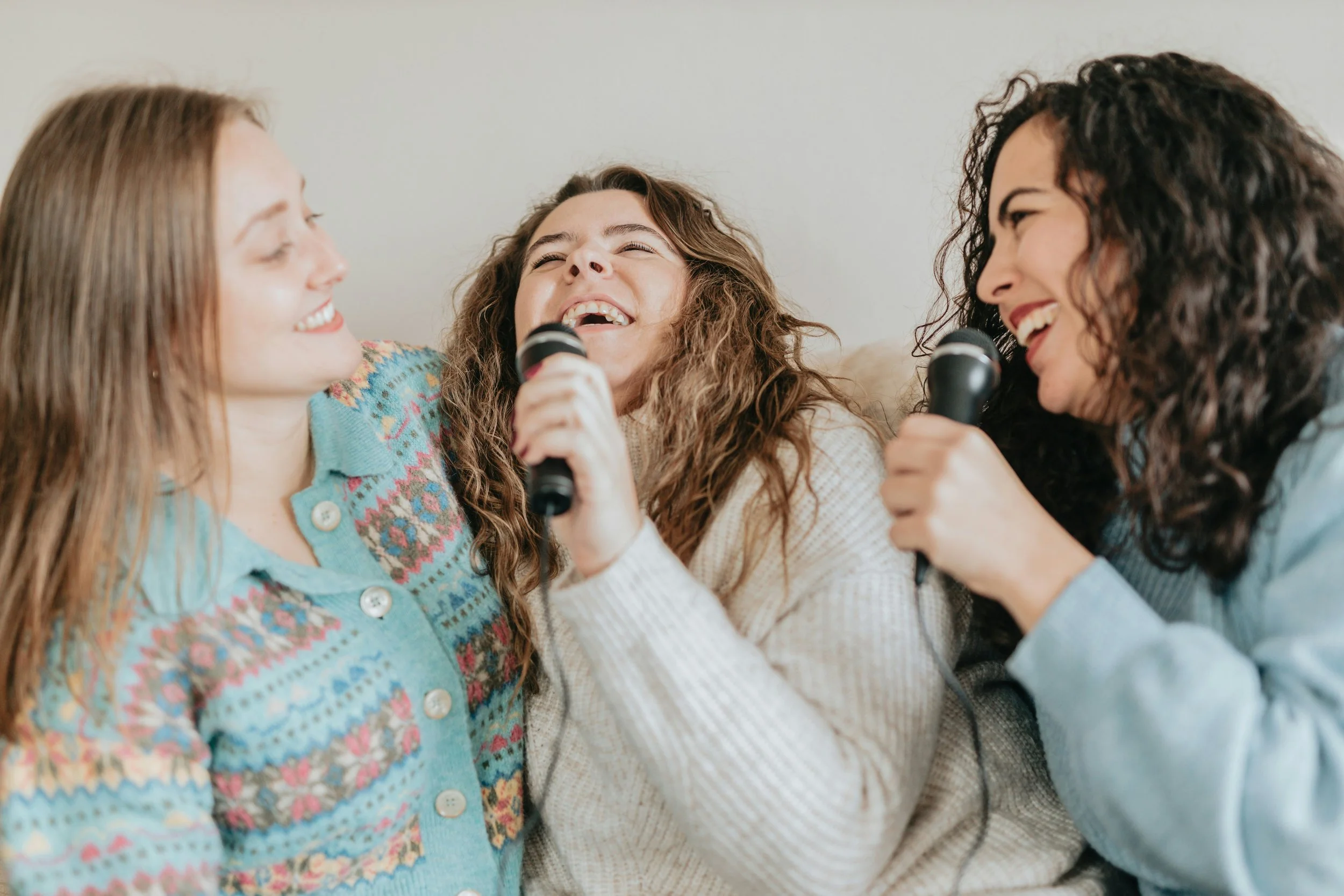 three women singing karaoke