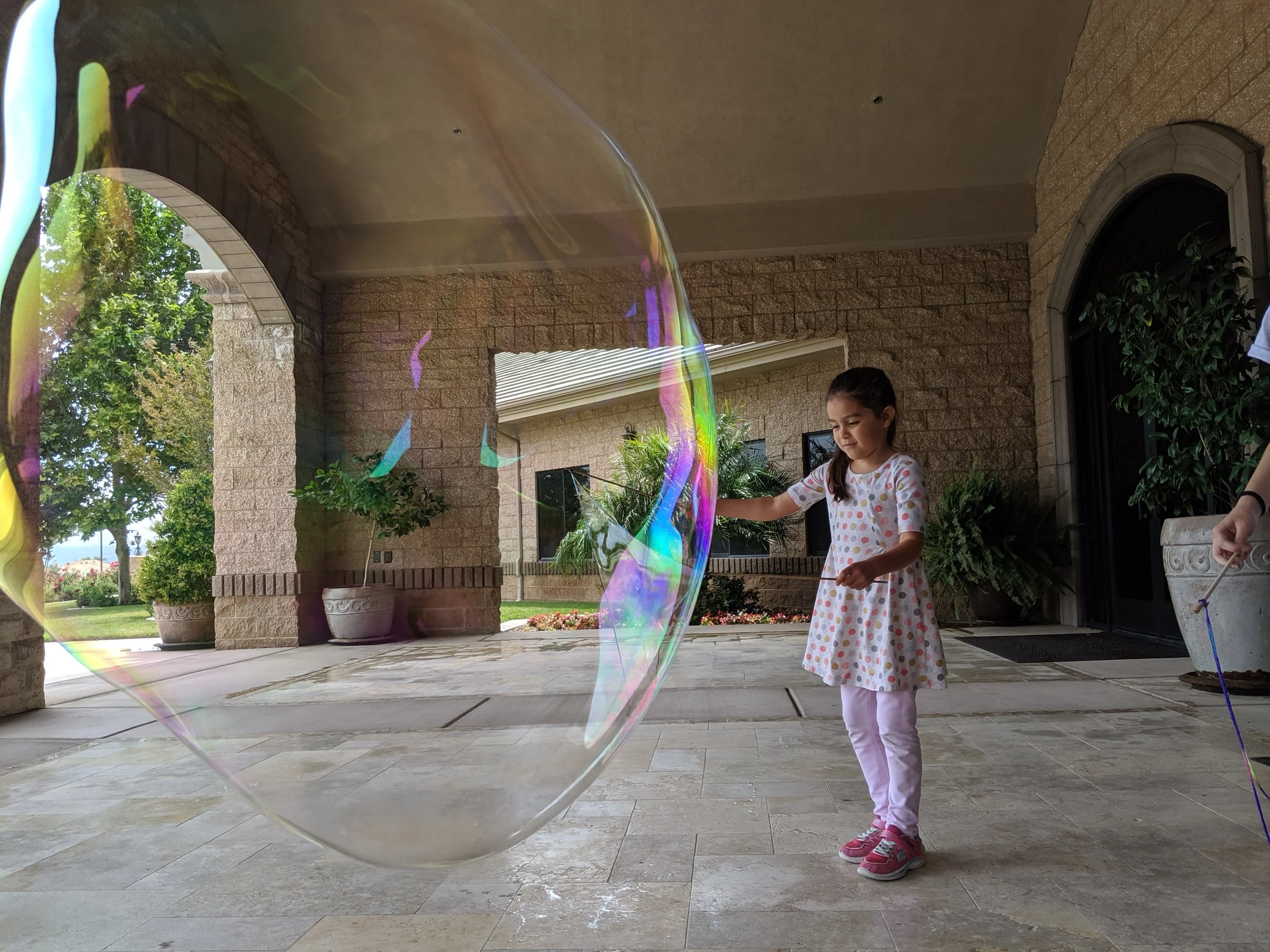 child making a giant bubble