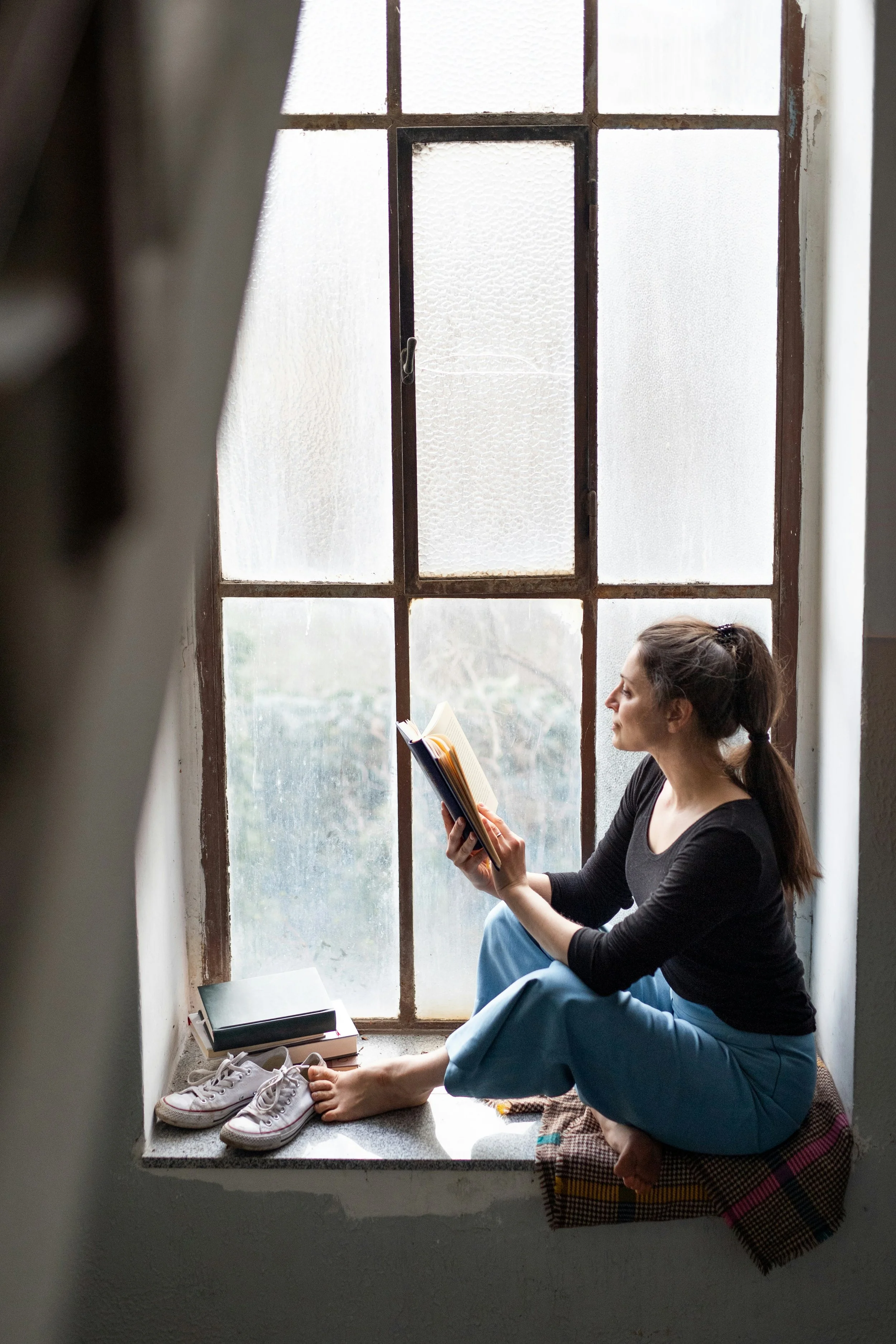 woman reading by a window