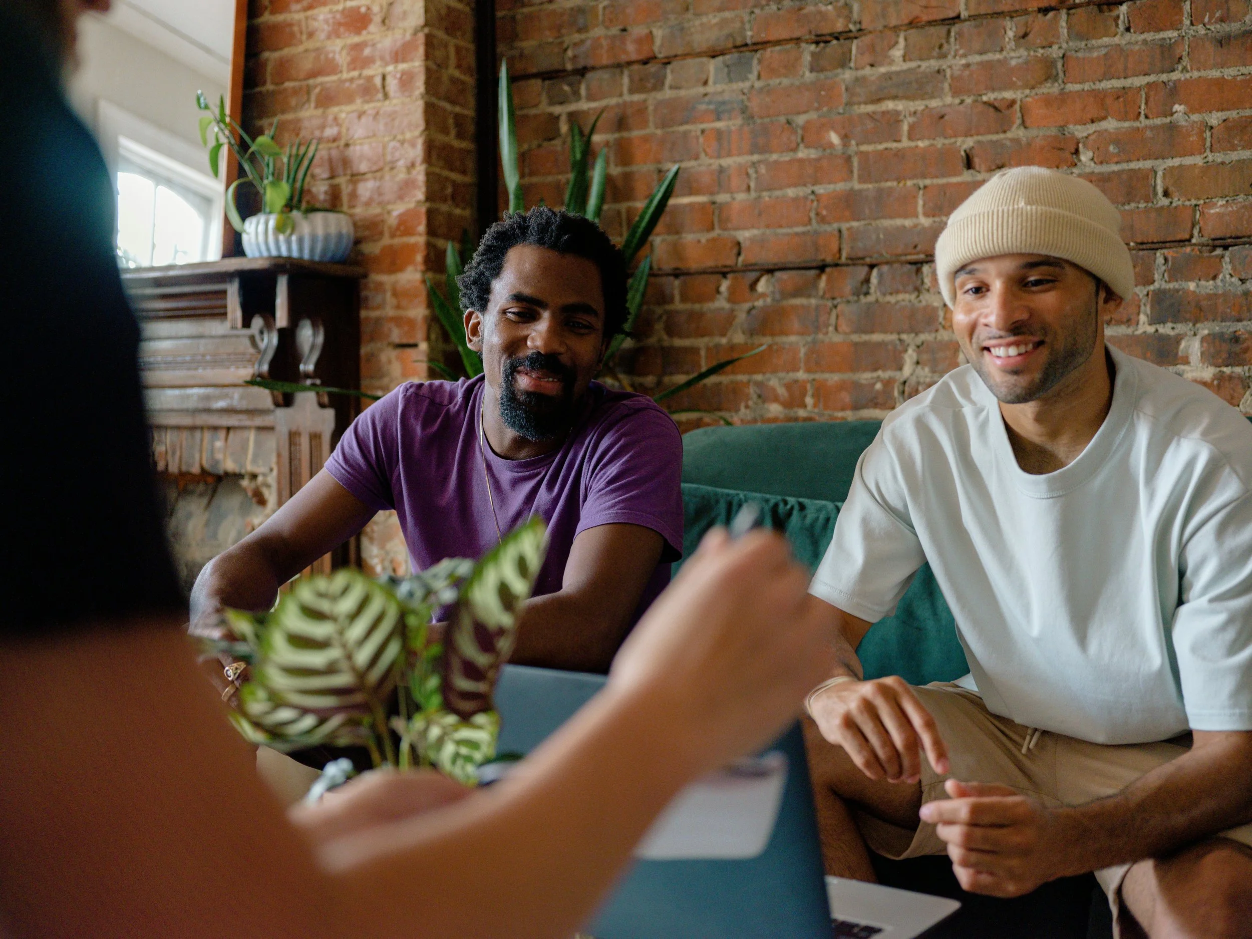 men sitting at a table smiling