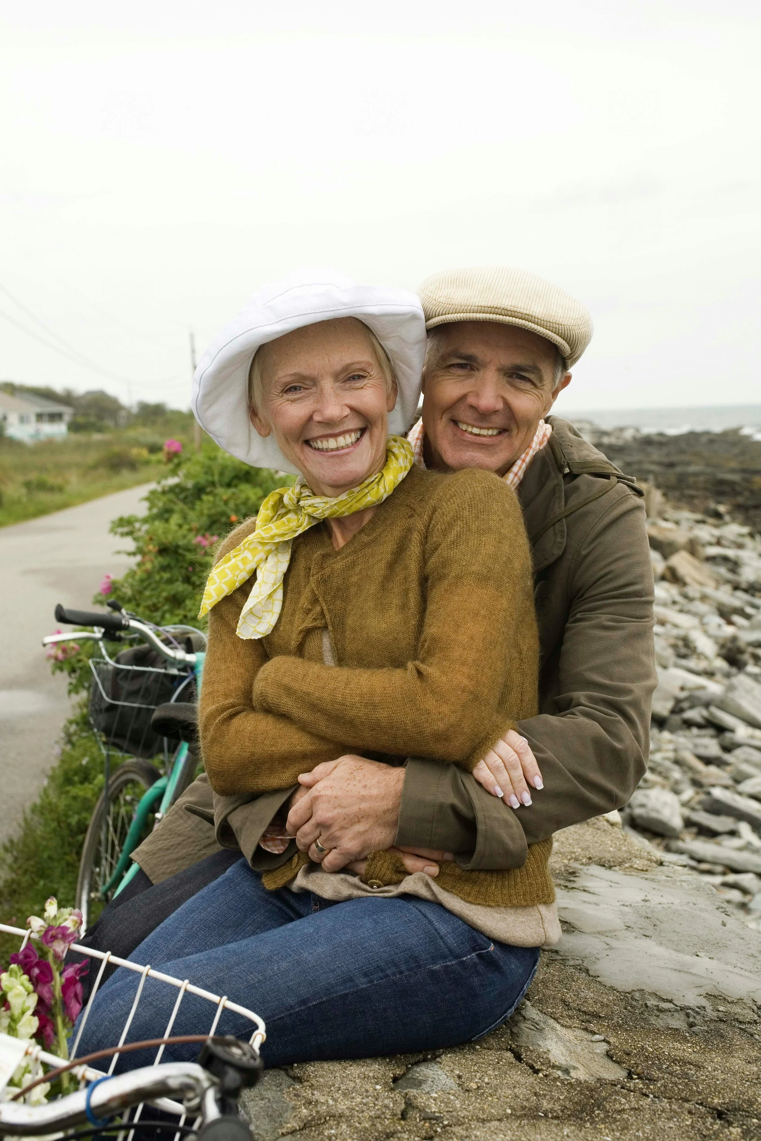 Older couple hugging during a bike ride representing healthy lifestyle and emotional wellness in Ogden Utah