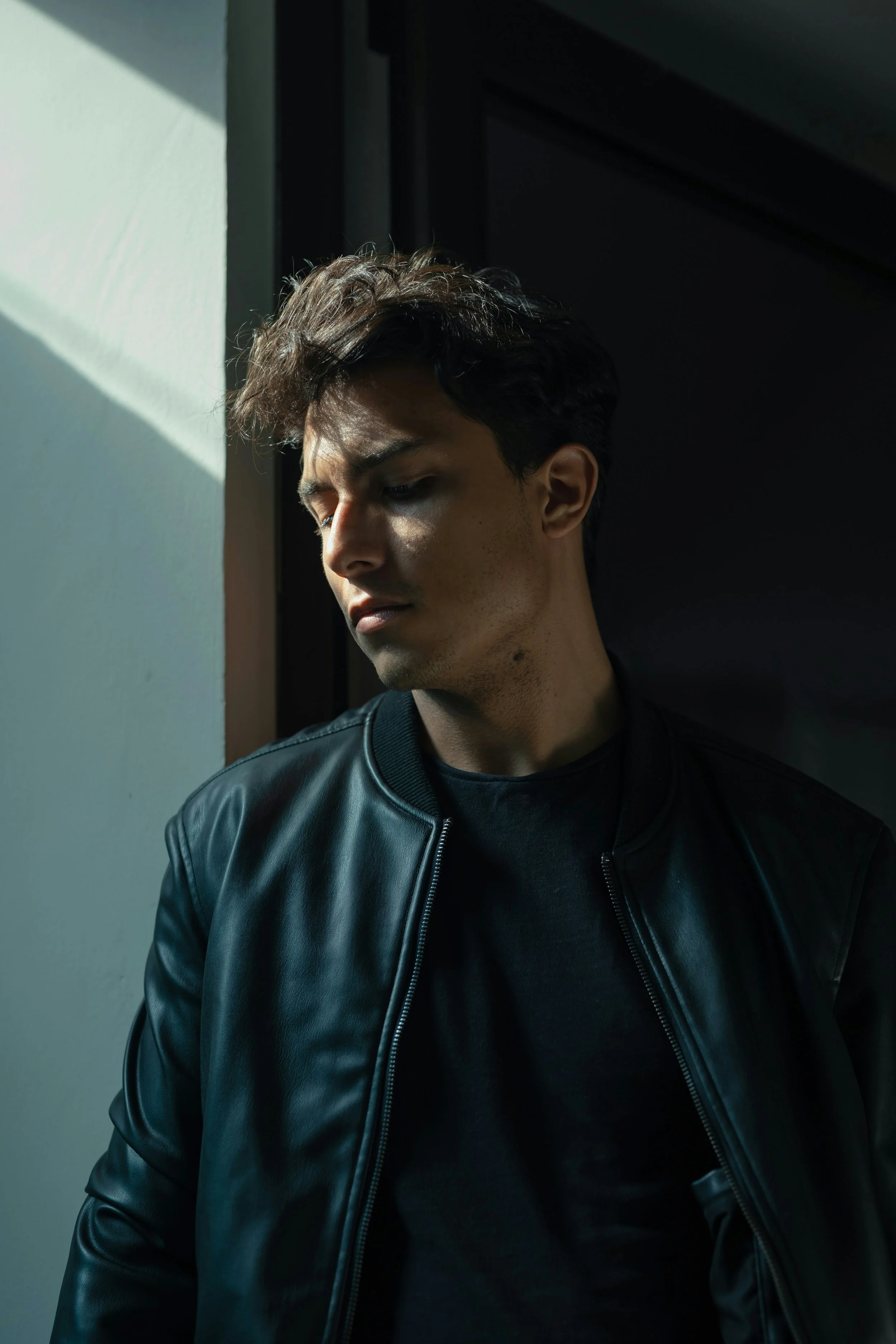 man resting against a wall