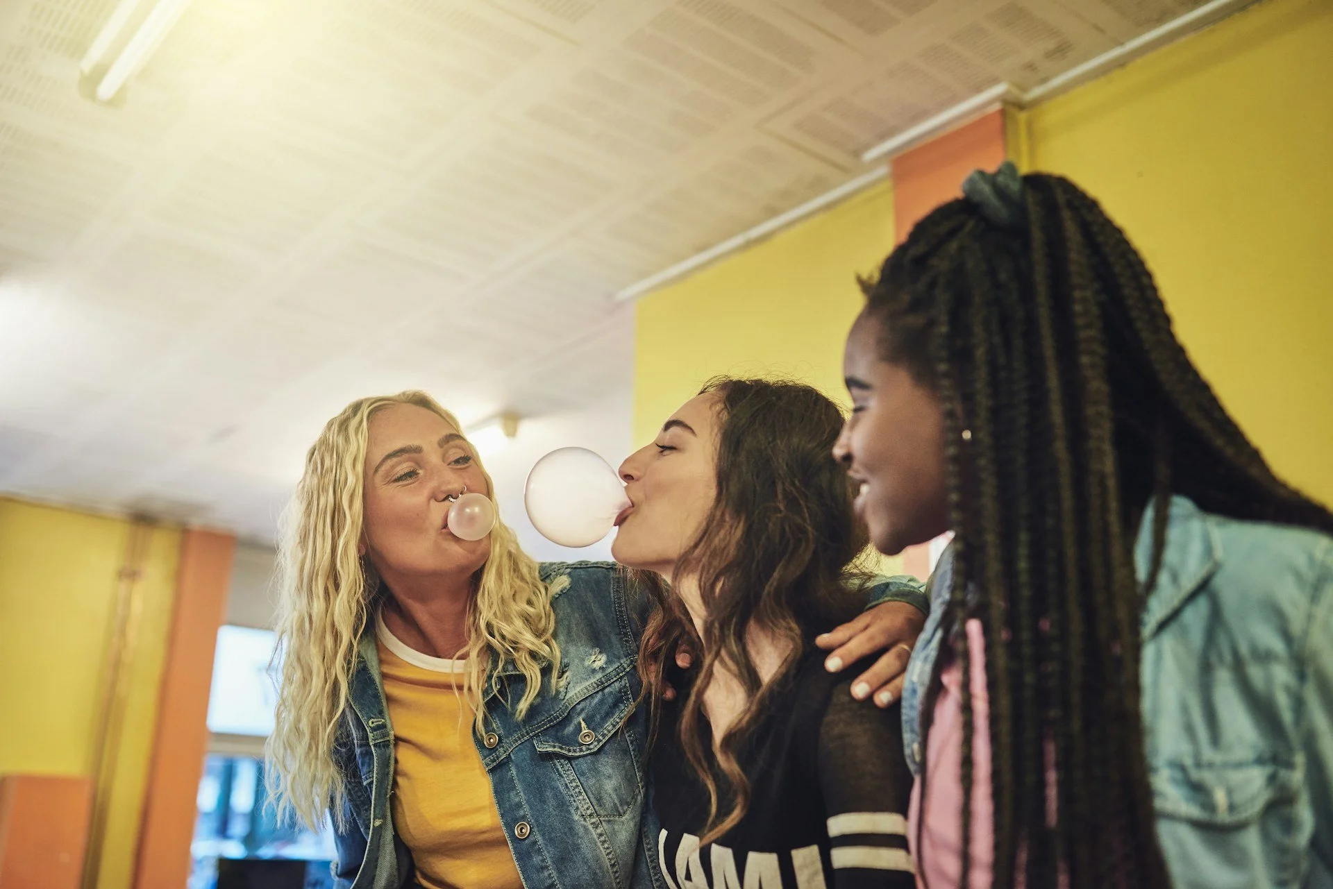Three women blowing bubbles and laughing together after treatment for misophonia in Ogden Utah mental health clinic