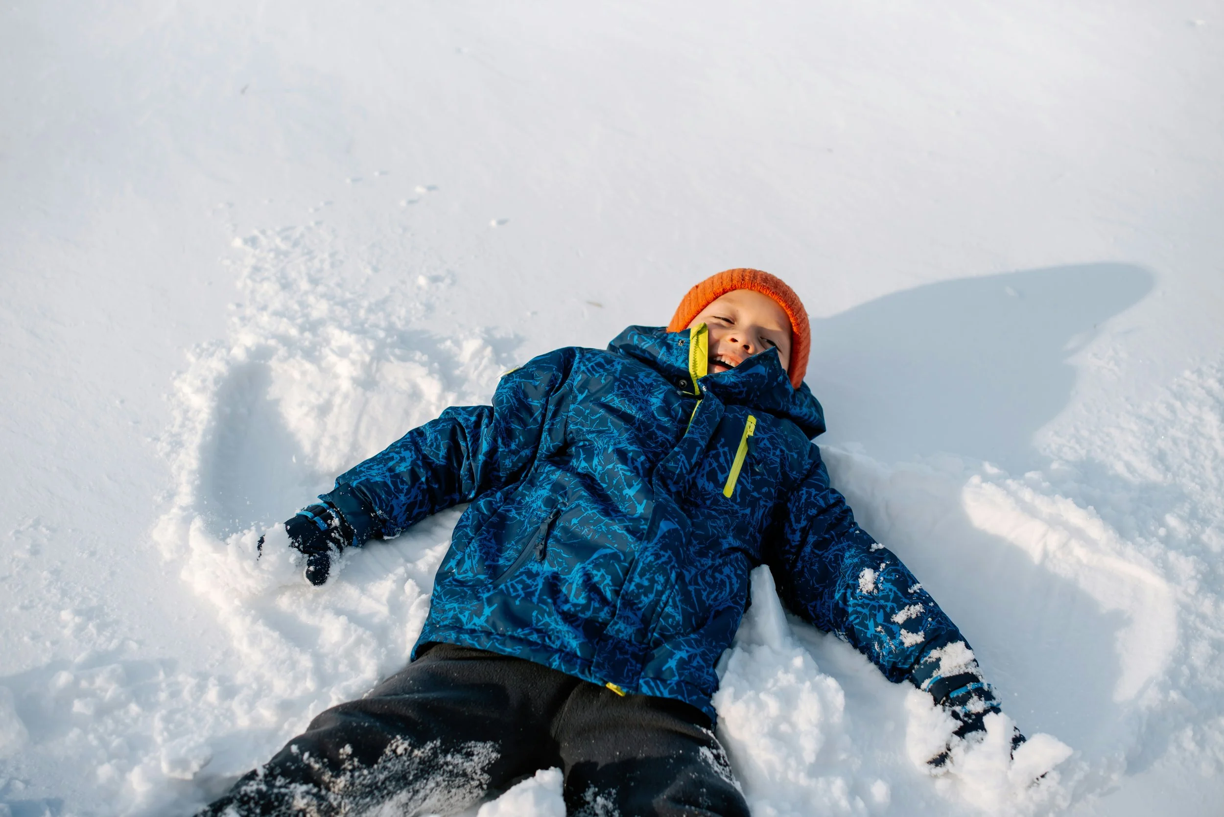 child making a snow angel