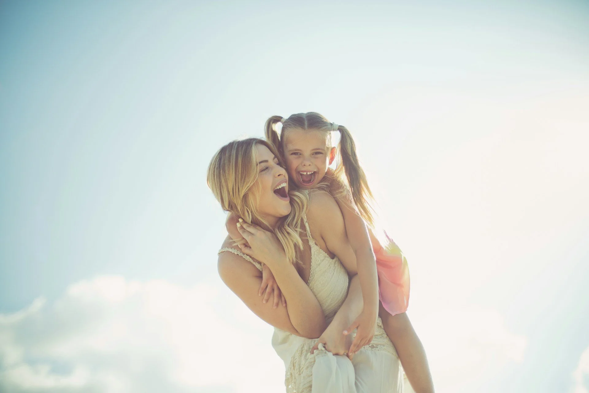 Child laughing on mother’s back during supportive child psychiatry care in Ogden Utah