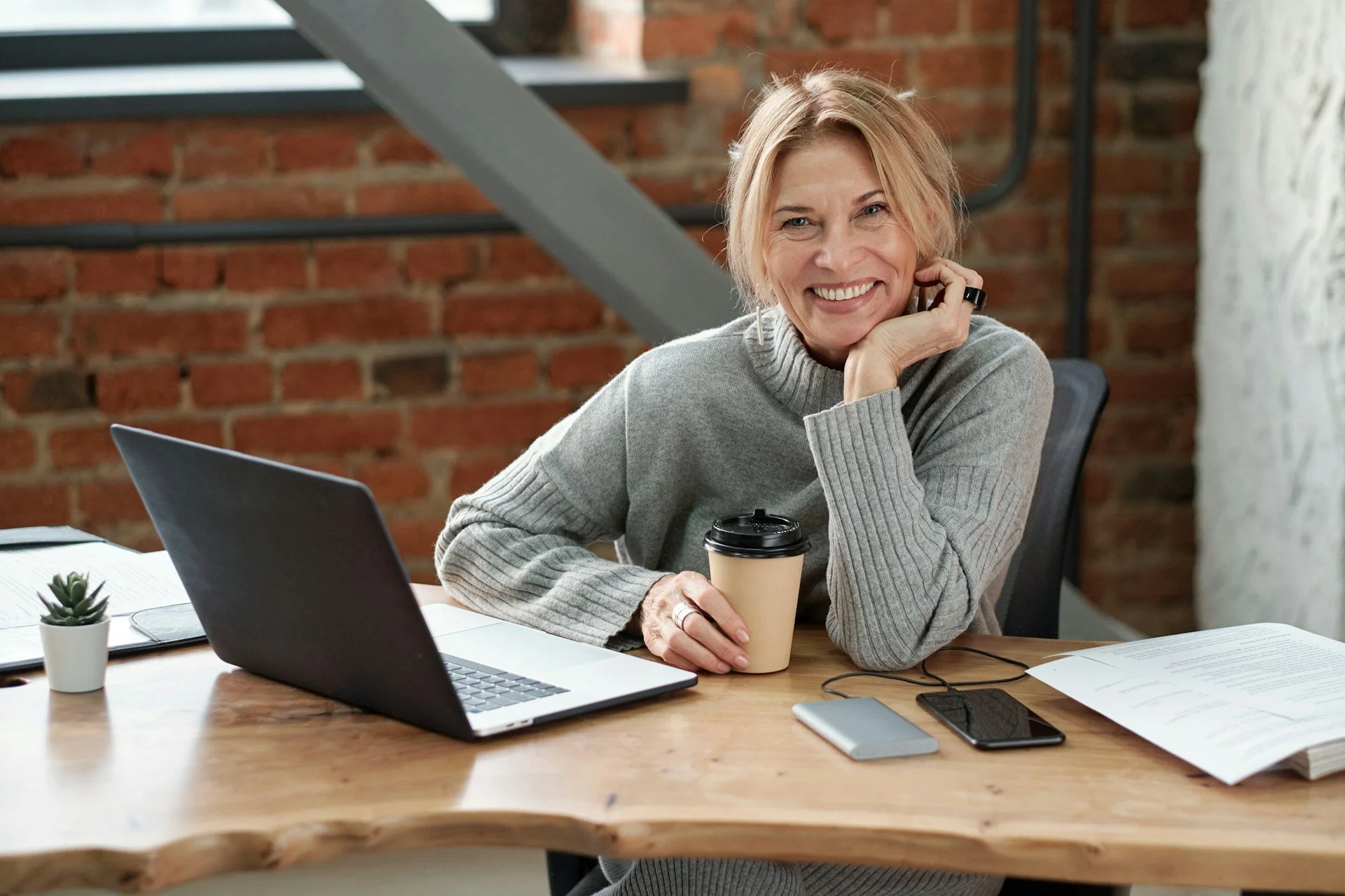 Confident woman entrepreneur working at a desk representing focus and productivity with ADHD treatment in Ogden Utah