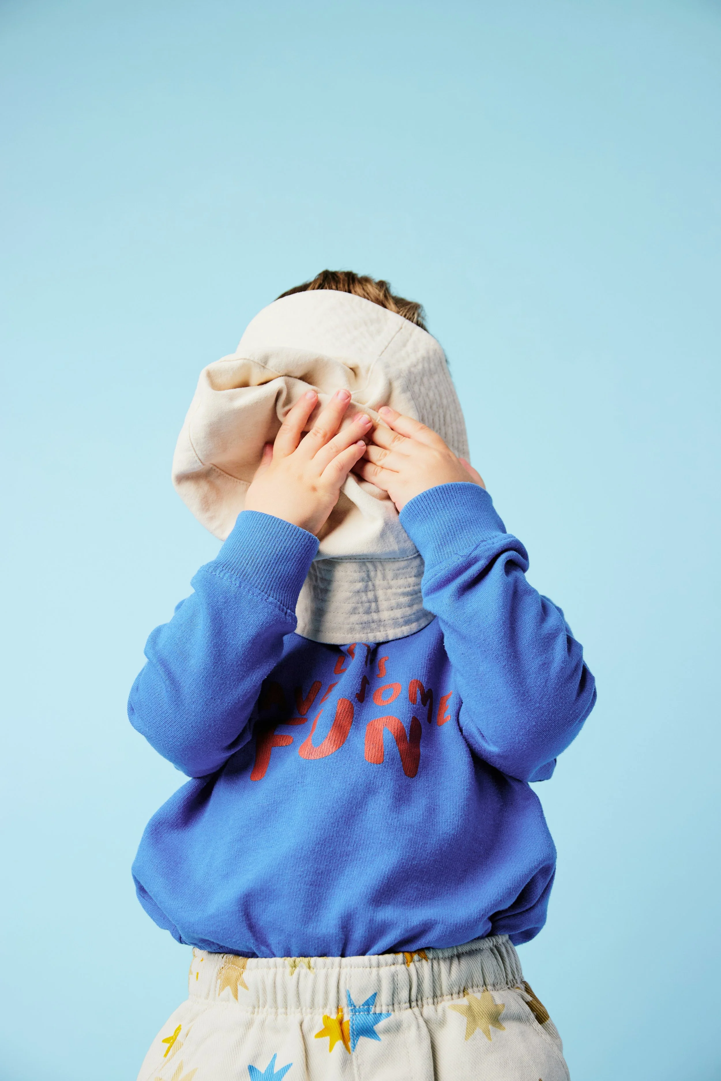 child hiding their face
