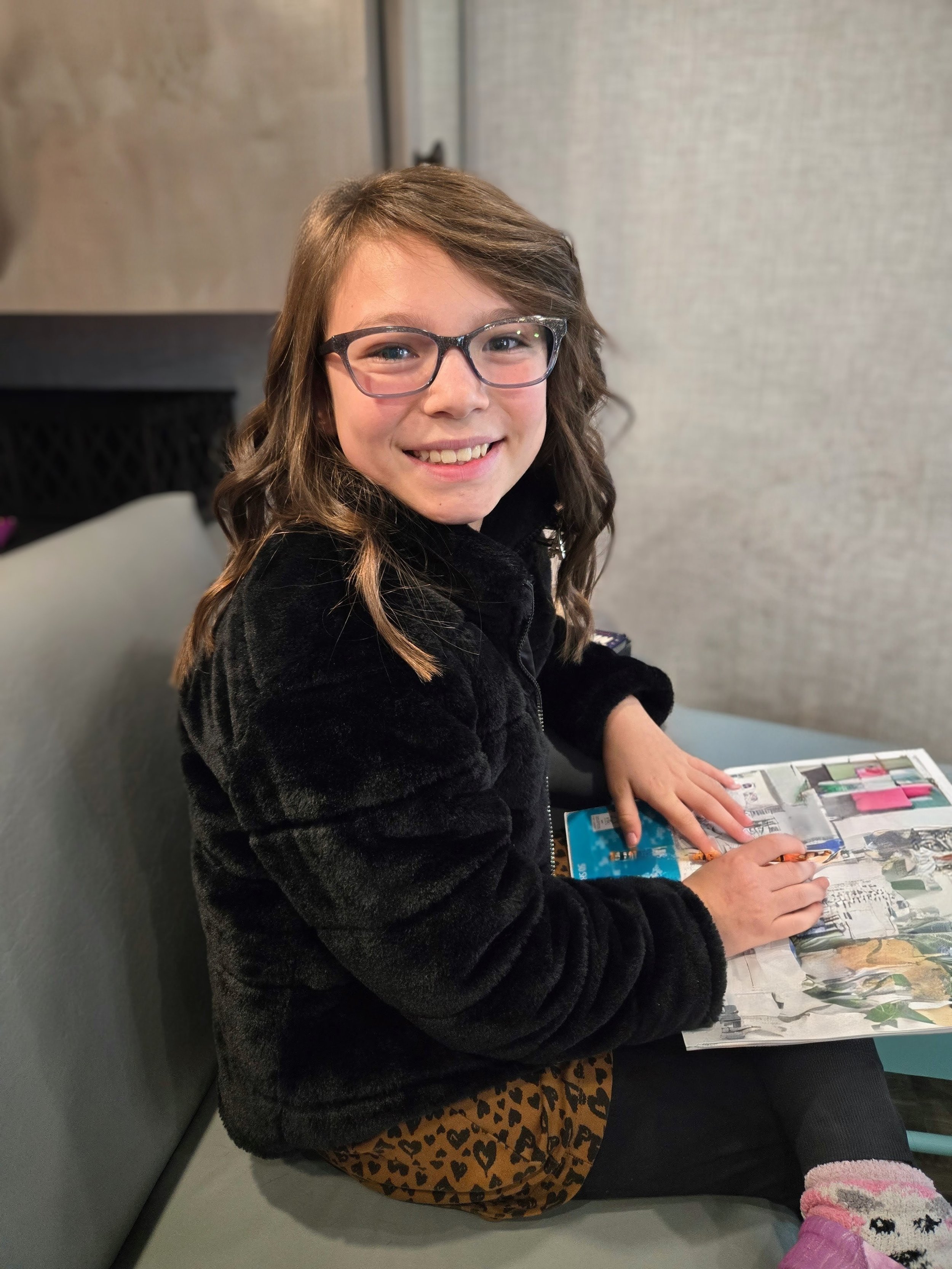 Confident student smiling while reading with improved attention after ADHD treatment in Ogden Utah