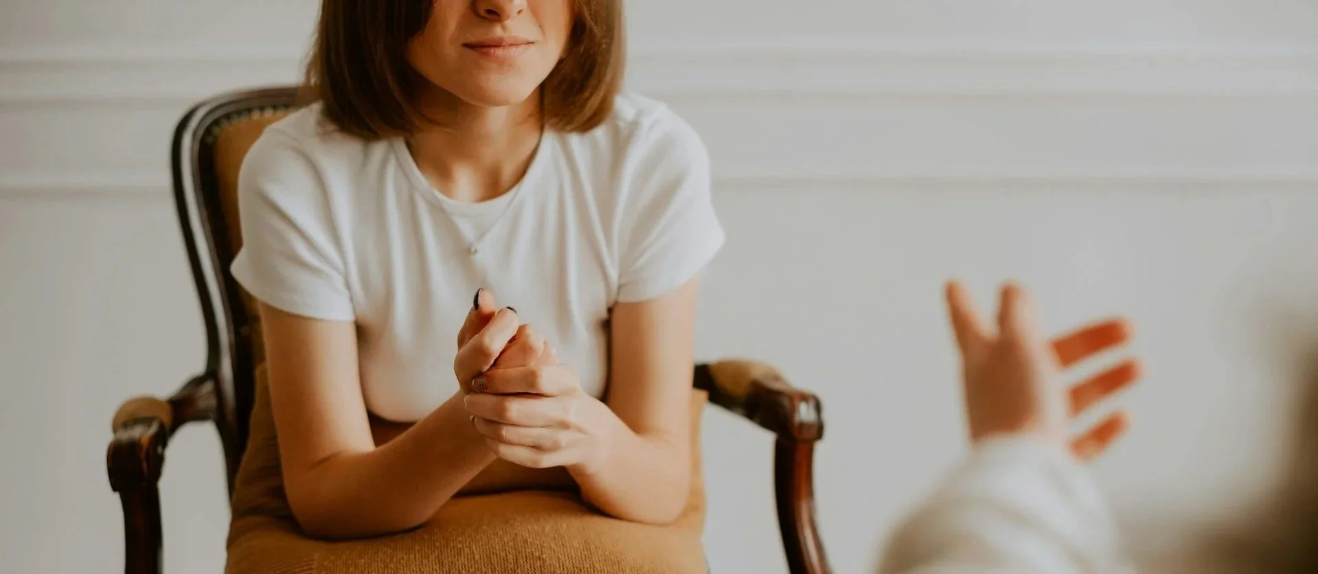 Patient sitting in a chair speaking with a therapist during a mental health counseling session in Ogden, Utah