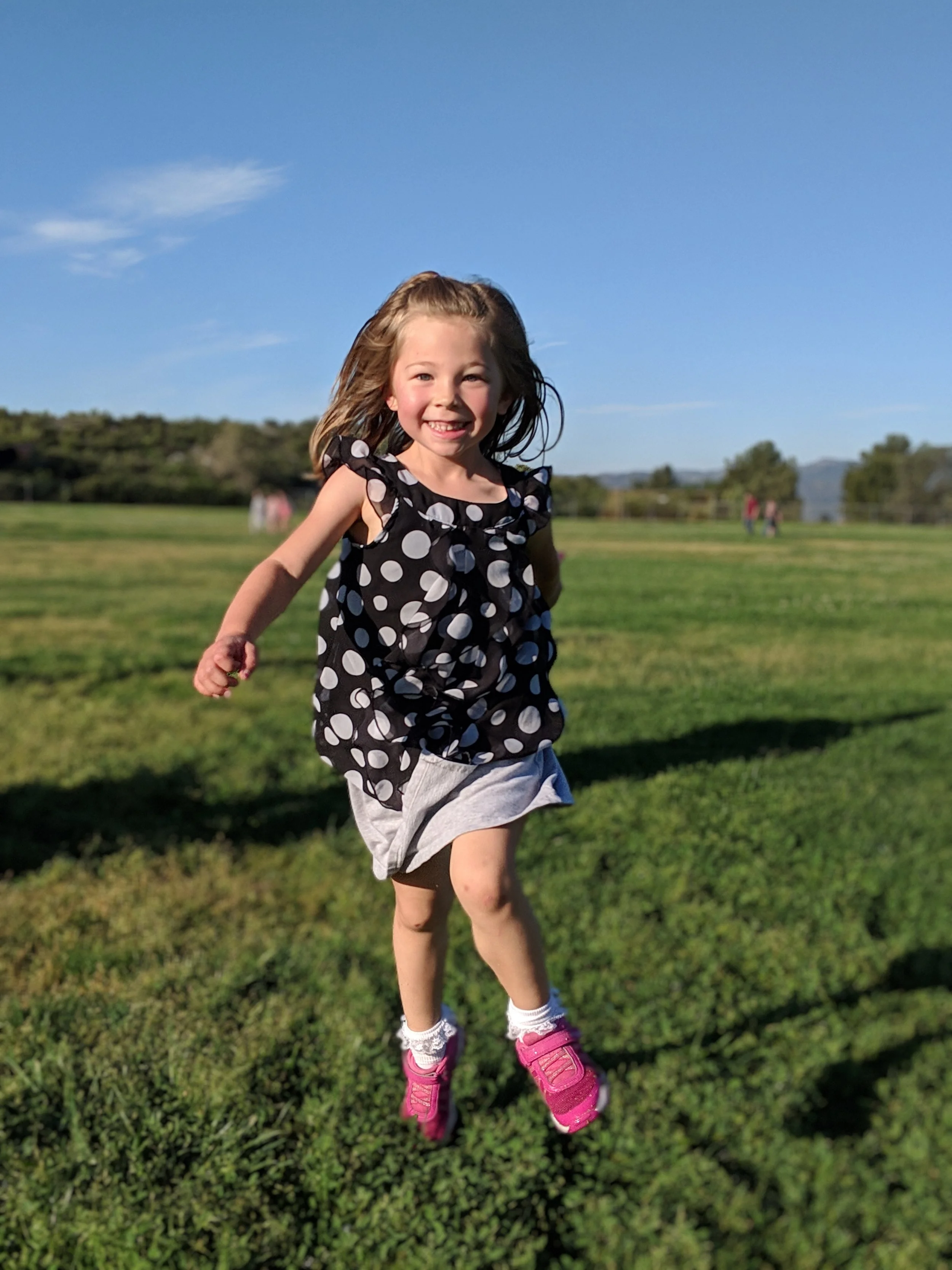 happy child running and smiling in a field