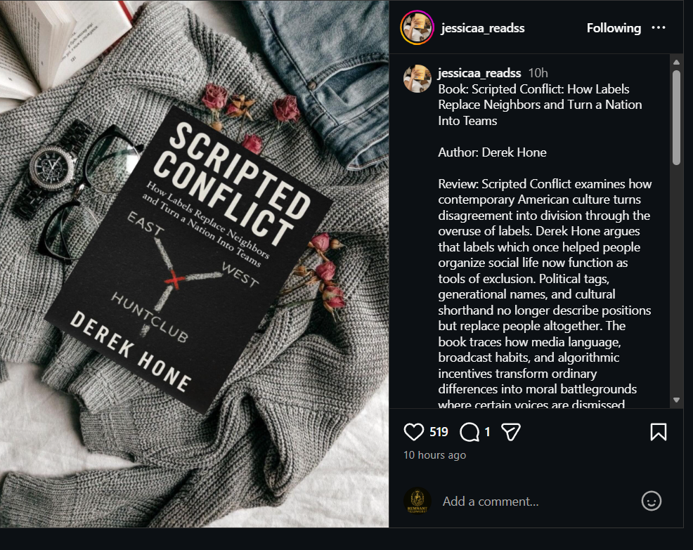 A book titled "Scripted Conflict" by Derek Hone resting on a textured gray fabric, accompanied by a pair of glasses, a watch, a partially visible open book, pink flowers, and a pair of jeans.