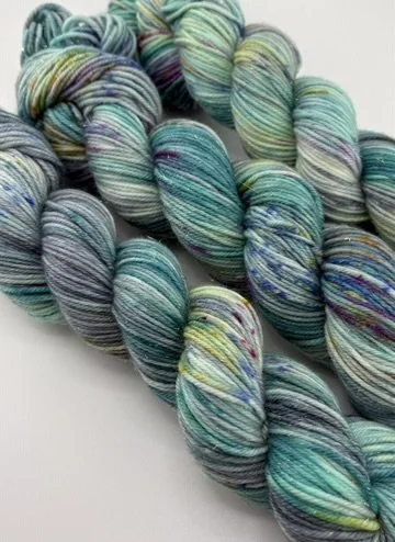 close up of 3 skeins of 75/20/5% merino and nylon and stellina sparkle