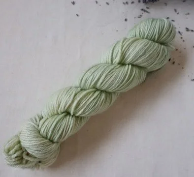 A single pale green skein from the Queen’s Attendant Set, styled with dried lavender to emphasise the natural, story‑driven palette.