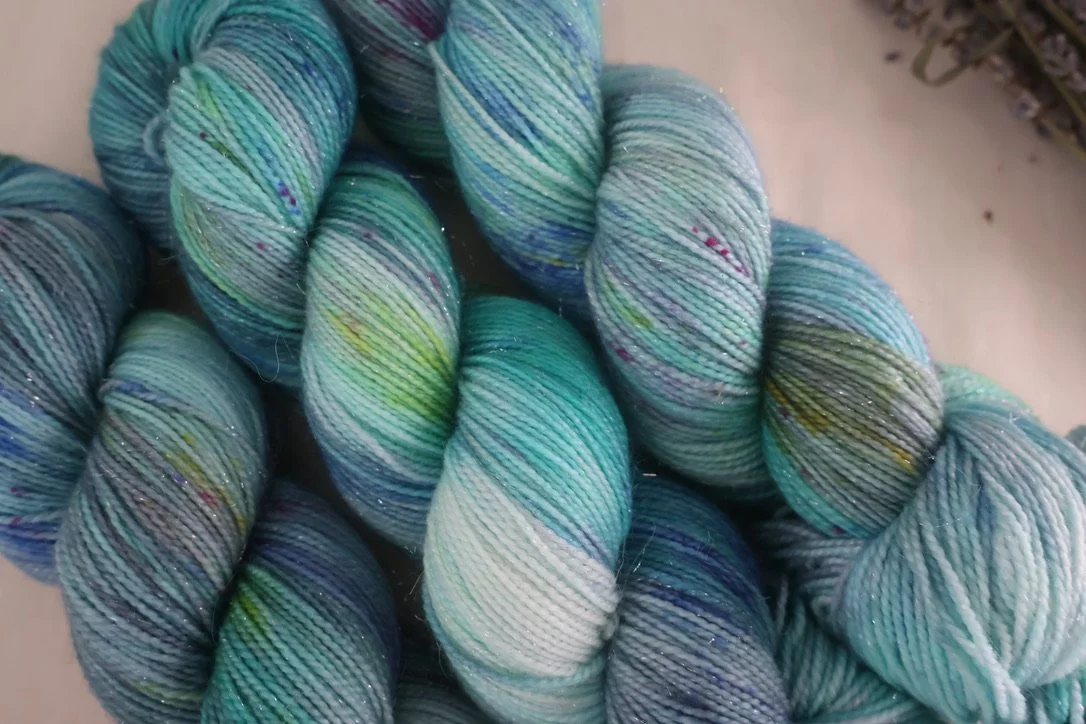 Gloaming Waters is a twilight‑inspired 4‑ply merino/nylon yarn with layered coastal blues and dusk‑lit tones. Hand‑dyed in Scotland in small batches.