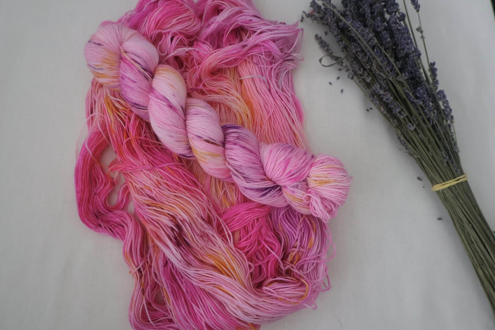 A vivid hand‑dyed colourway inspired by the Royal Botanic Garden Edinburgh. Lush pinks, violets, and warm botanical hues on a 4‑ply merino/nylon blend.