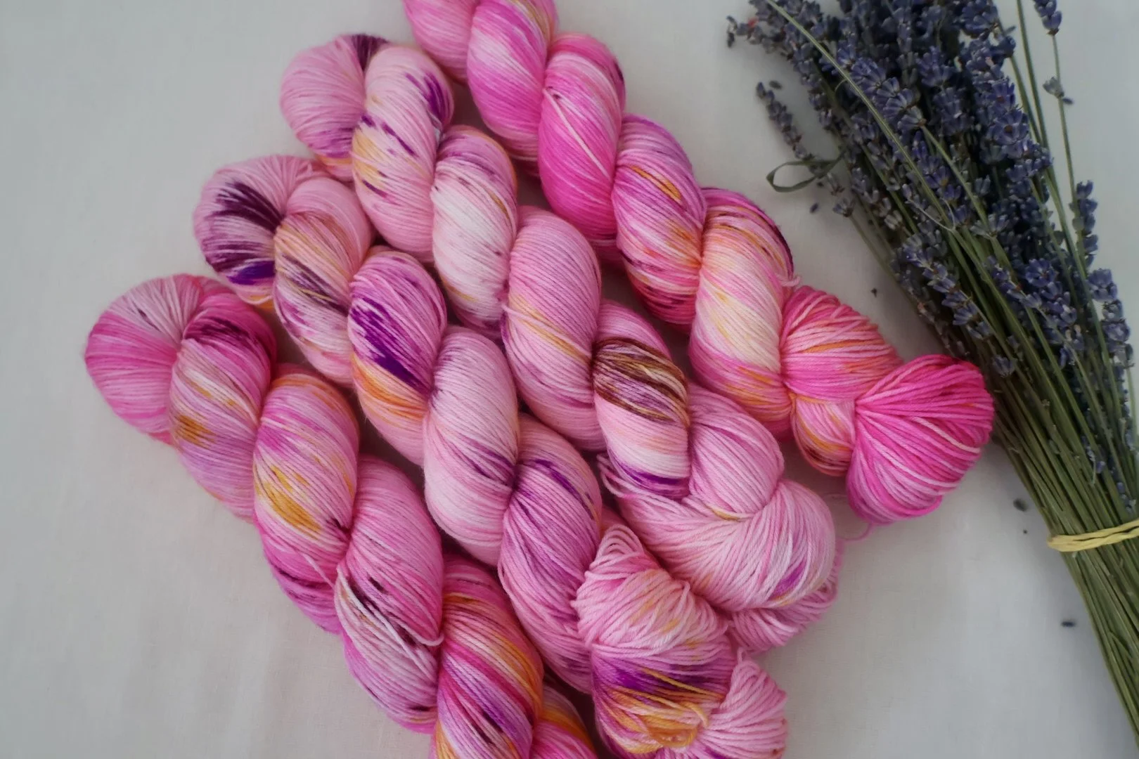 A vibrant floral colourway inspired by the Royal Botanic Garden Edinburgh. Hand‑dyed 4‑ply merino/nylon yarn with rich pinks, purples, and warm botanical tones.