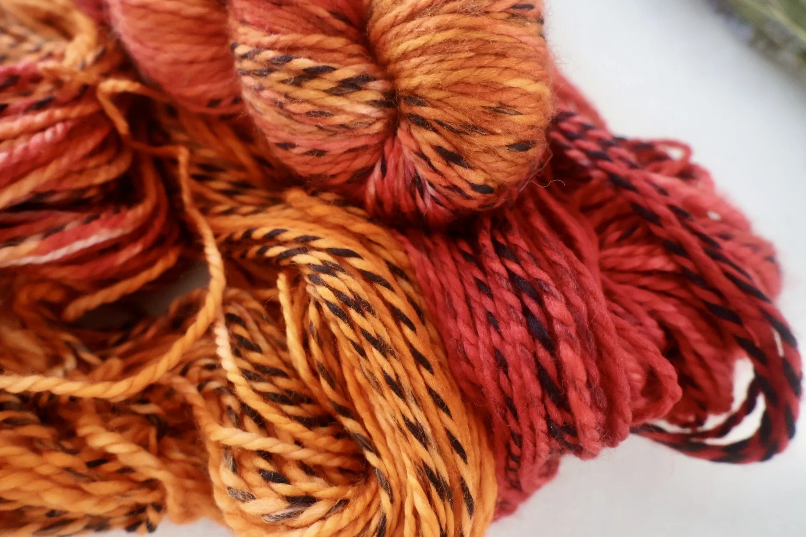Hand‑dyed Merino DK yarn in autumnal red, orange and gold tones inspired by Mary Barbour’s activism.