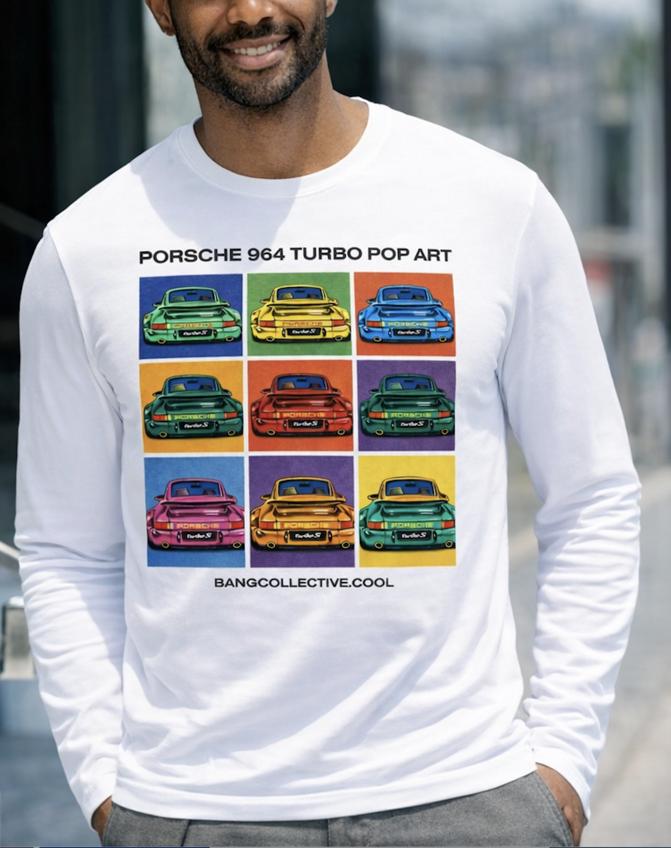 A man wearing a white long sleeve shirt with colorful pop art images of Porsche 964 Turbo cars on the front.