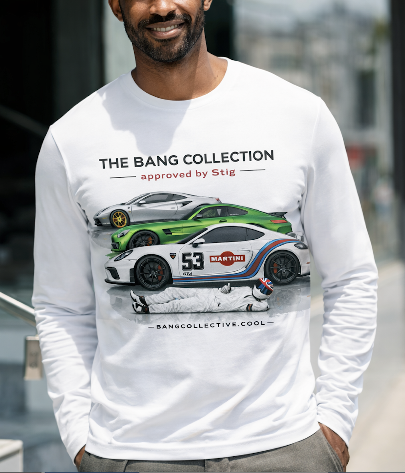 A man wearing a white long-sleeve shirt with racing car graphics and the words 'The Bang Collection approved by Stig' printed on it.