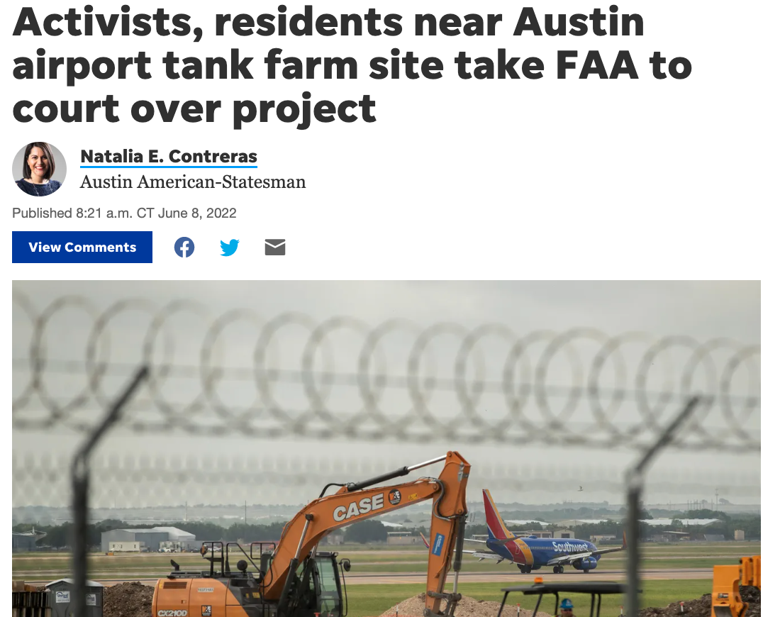 Construction site at an airport with an orange CASE excavator, a Southwest Airlines airplane on the runway, and a barbed wire fence in the foreground.