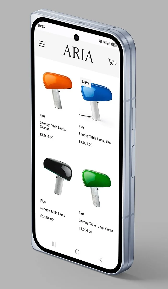 Smartphone displaying an online store app called ARIA with colorful snoopy table lamps in orange, blue, black, and green for sale.