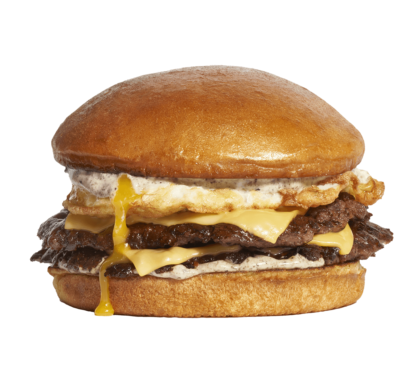 Multiple beef patties, cheese, fried egg, and sauce in a sandwich bun