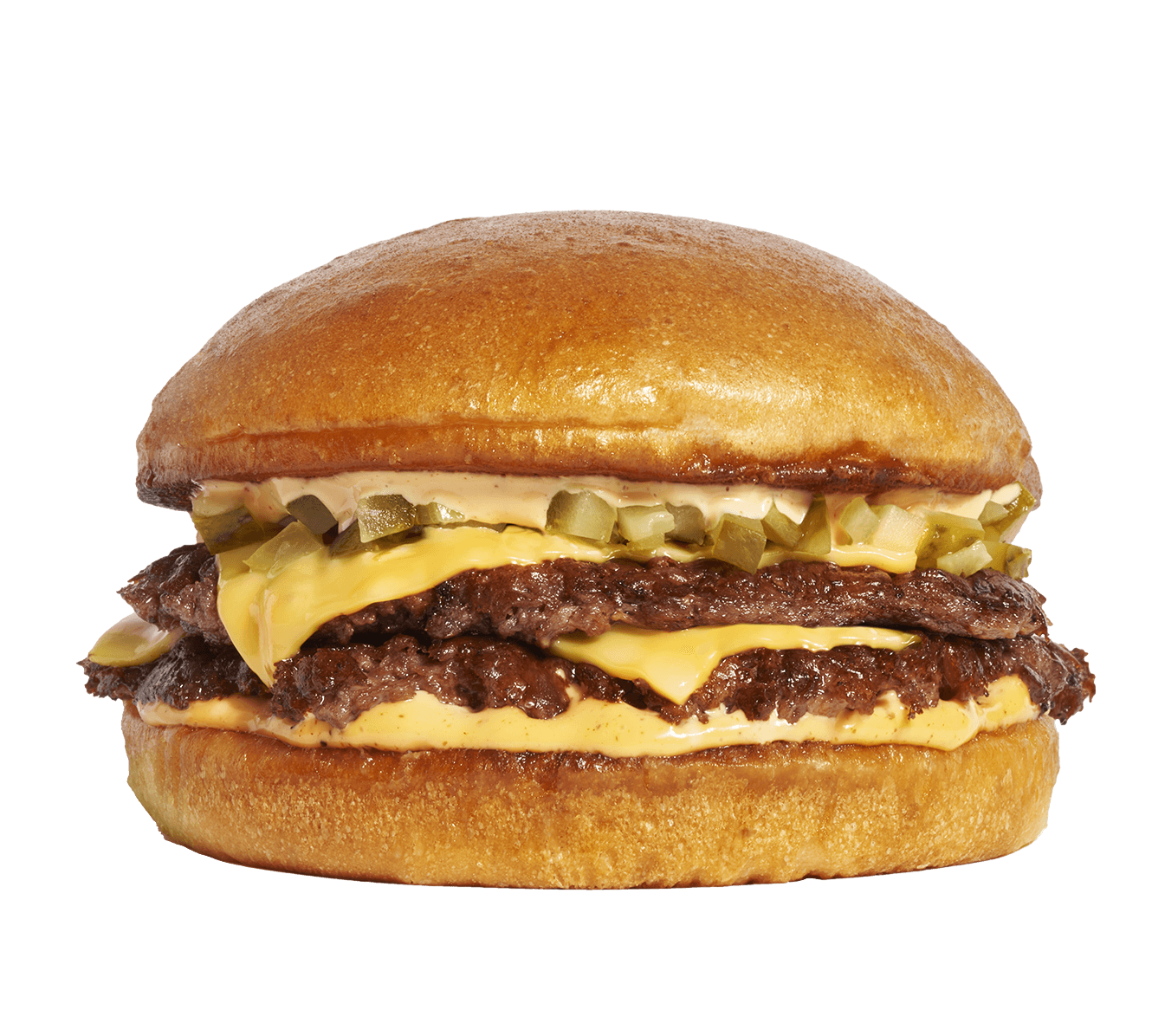 Close-up of a cheeseburger with two beef patties, melted cheese, pickles, and sauce in a toasted bun.