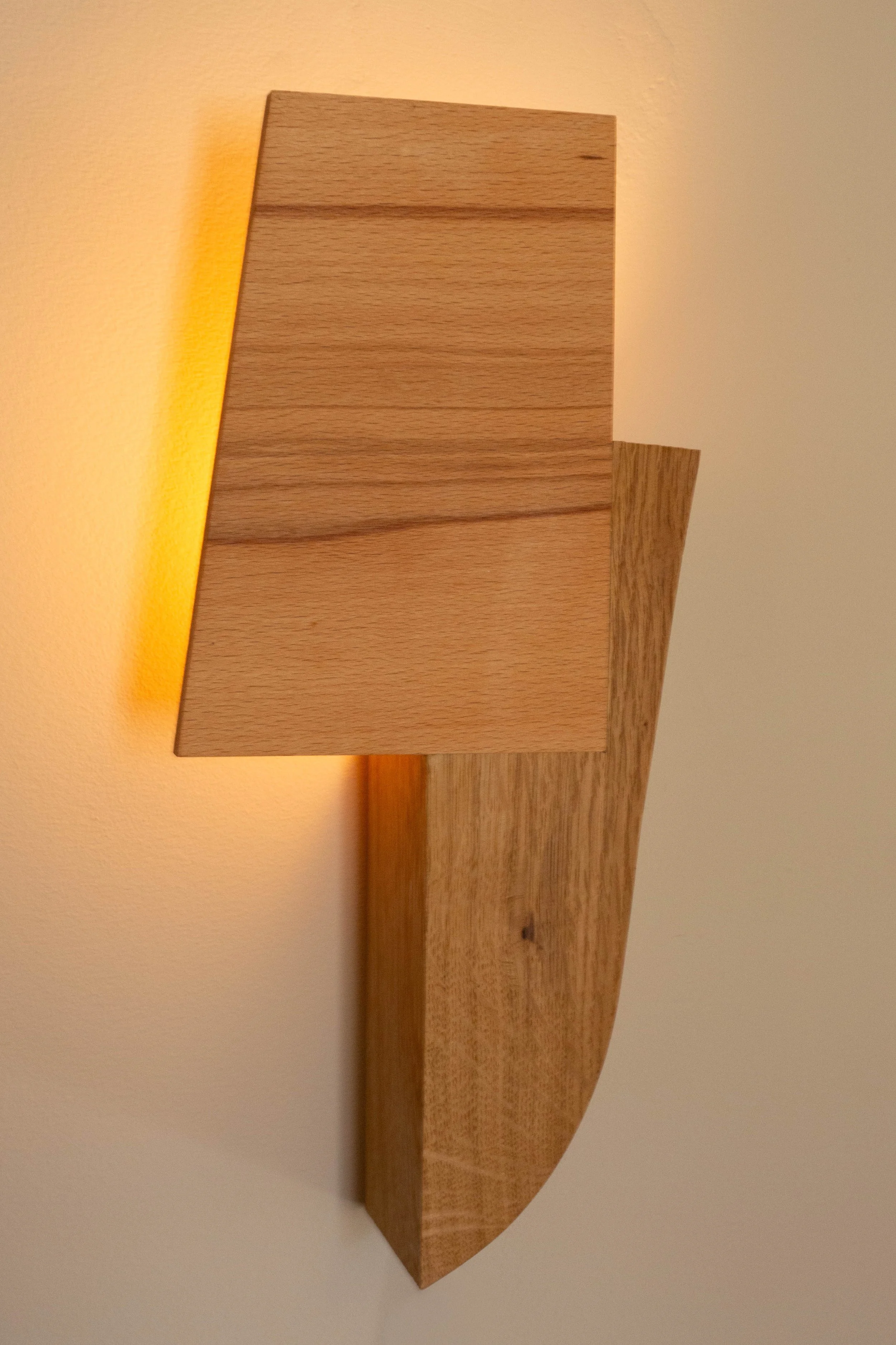 Sculptural hardwood wall light, warm ambient glow another angle