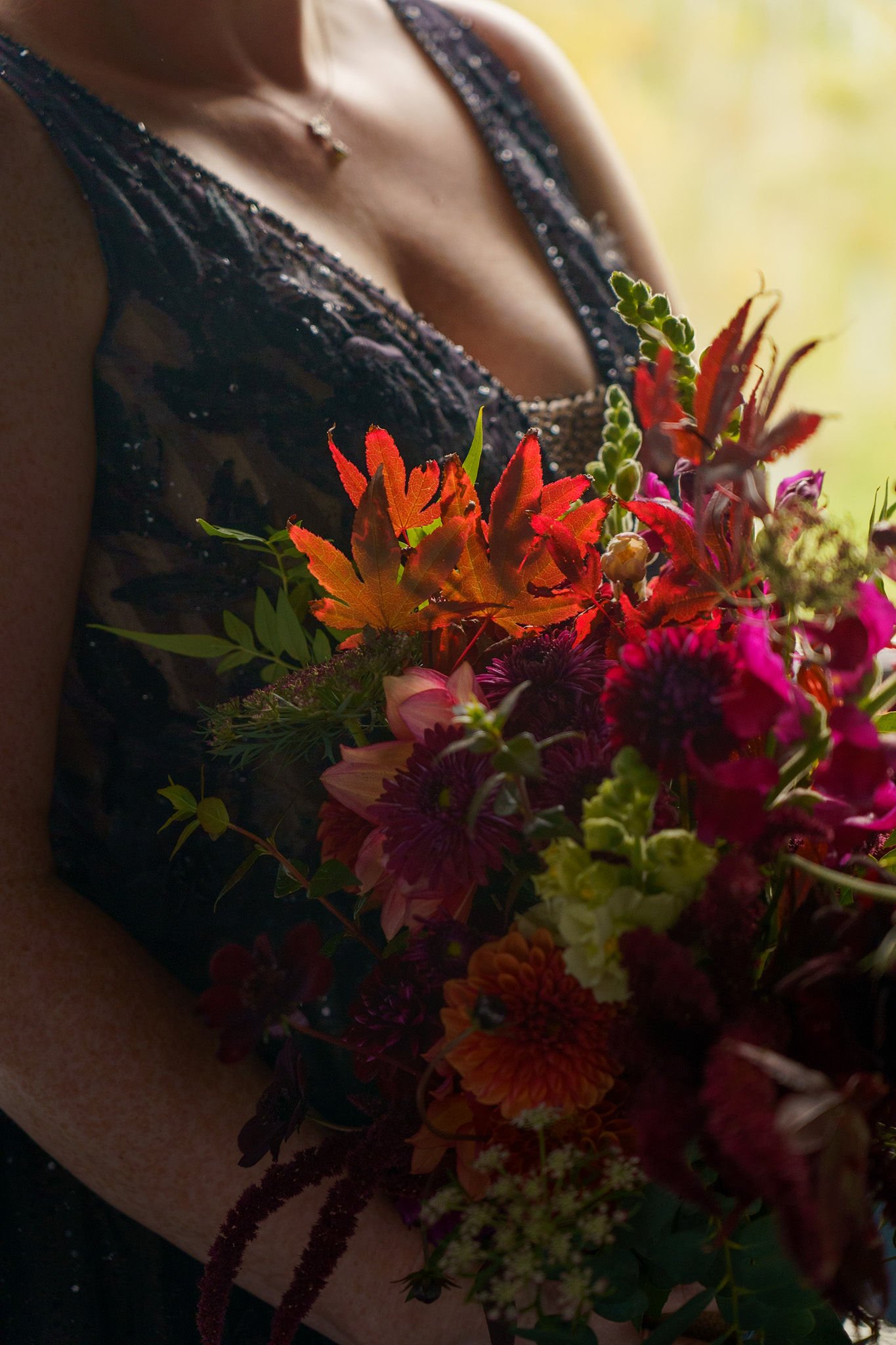 Bride in a black wedding dress holding bouquet