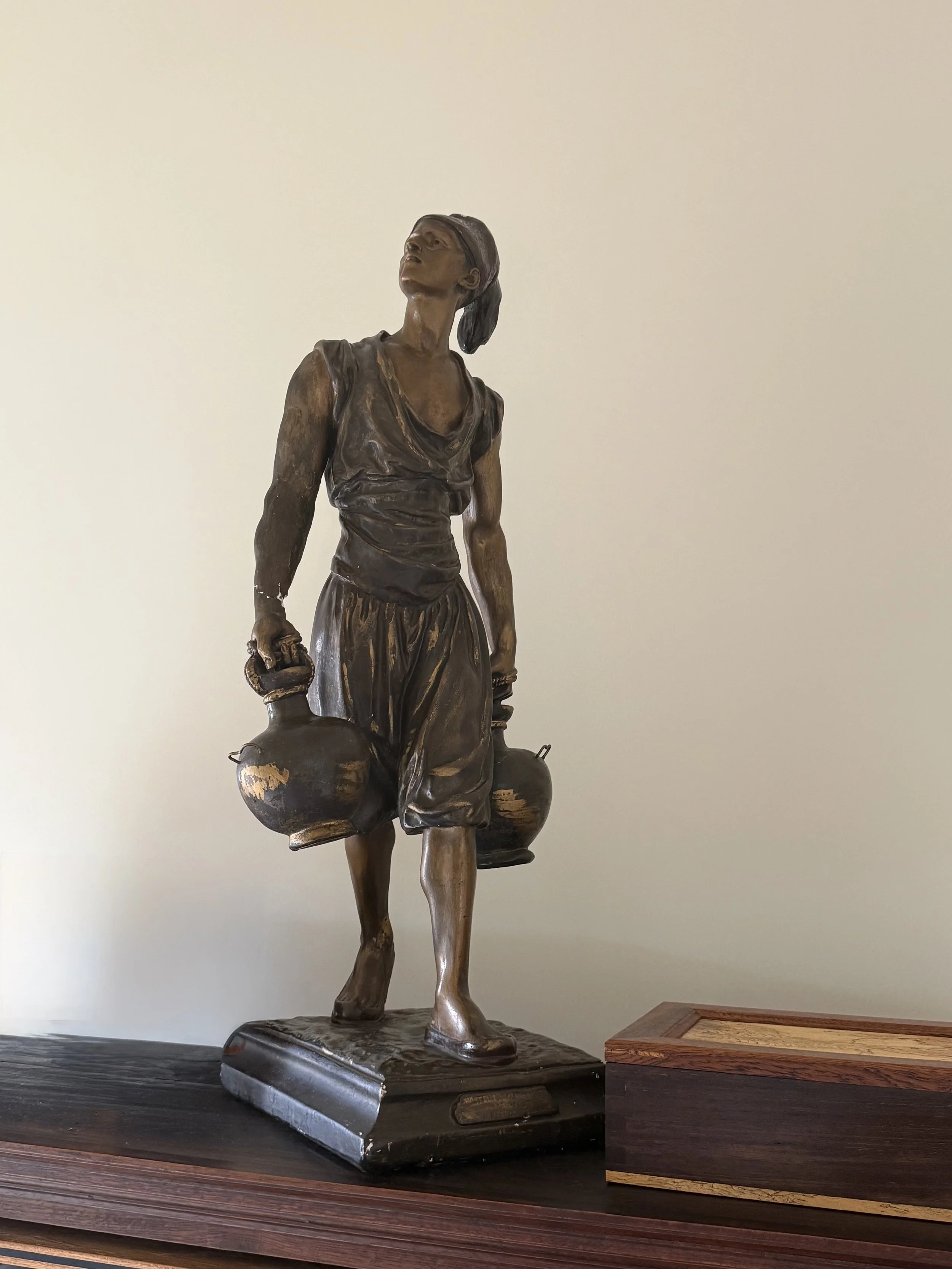 Large patinated plaster statue after Marcel Debut (1865-933), "Porteur d'Eau Tunisien"