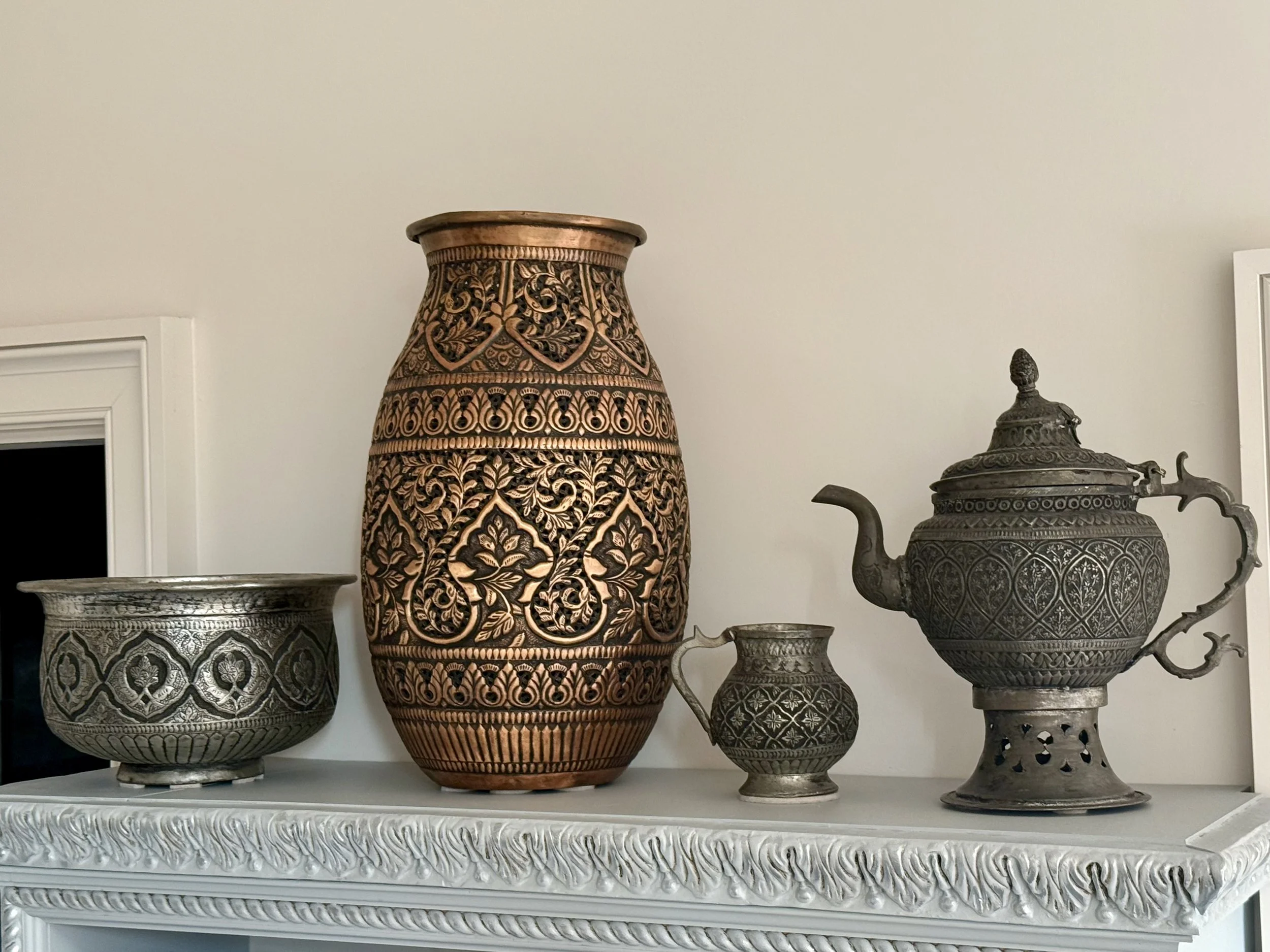 Collection of ornate, hand-decorated metal vessels