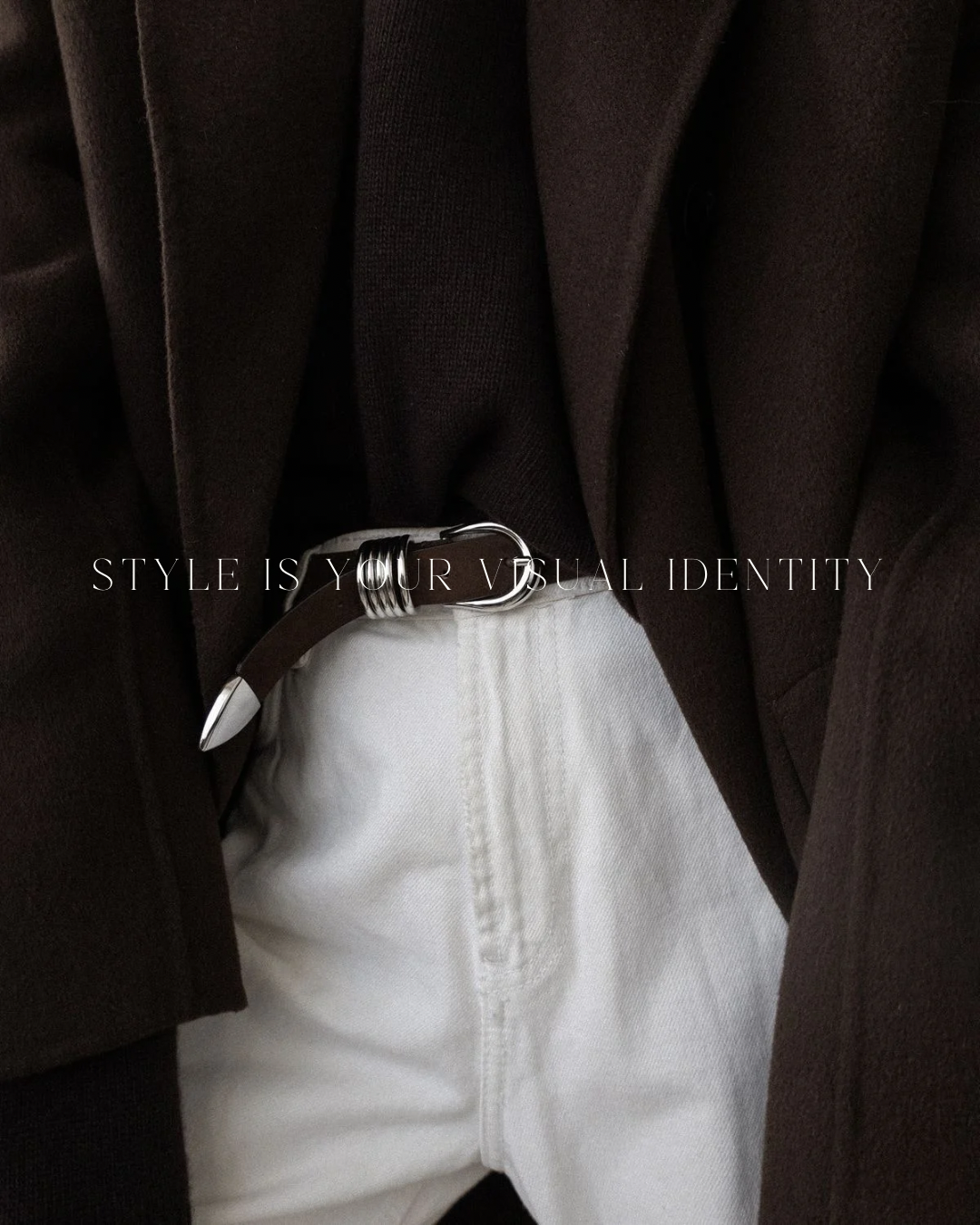 Close-up of a person wearing a dark brown blazer and a black top, with a silver belt and white pants, with the text "STYLE IS YOUR VISUAL IDENTITY" overlaid.