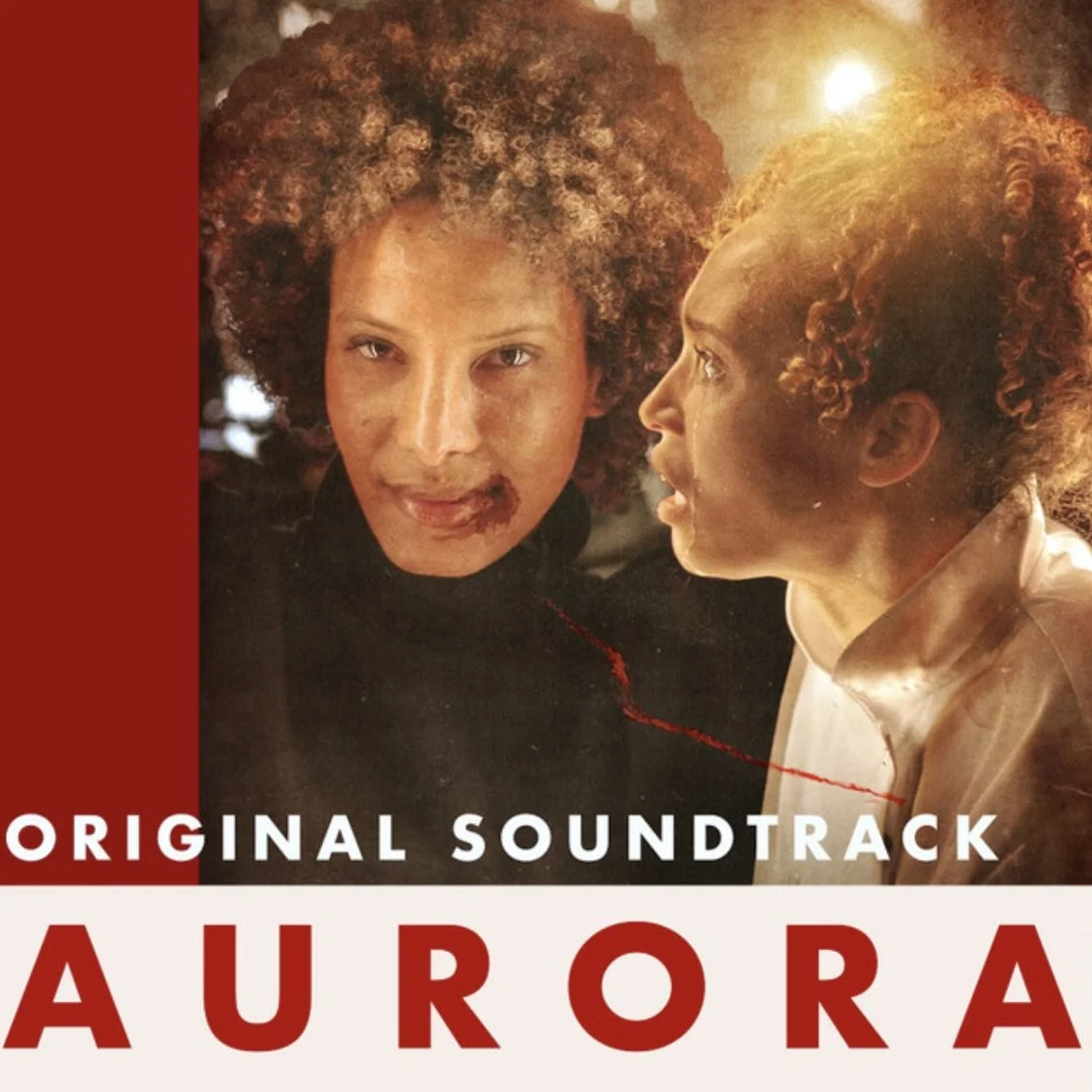 The album cover for the soundtrack of the movie 'Aurora', featuring two women with curly hair, one with fair skin and the other with darker skin, standing close together with a warm glowing light behind them.