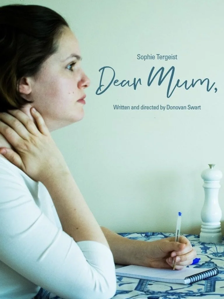 Book cover titled "Dear Mum" by Sophie Tergiest, written and directed by Donovan Swart, featuring a woman with short brown hair and fair skin resting her chin on her hand while holding a pen, seated at a table with a notebook, in front of a light green wall with a white decorative object.