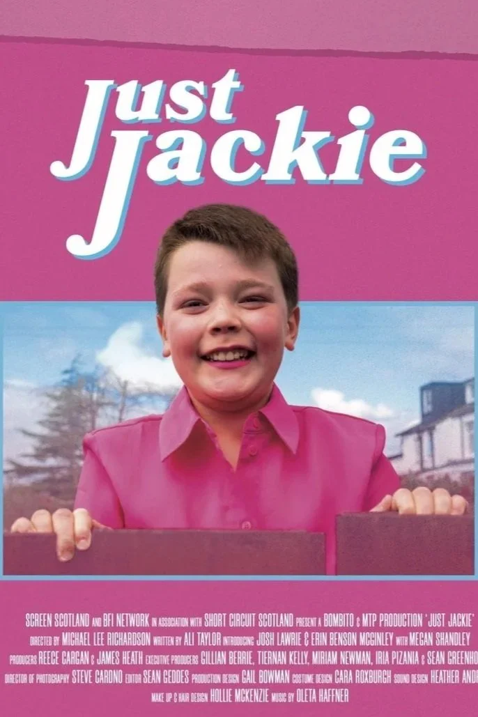 Poster for the short film 'Just Jackie' featuring a smiling young boy in a pink shirt against a blue sky background with the title 'Just Jackie' at the top.