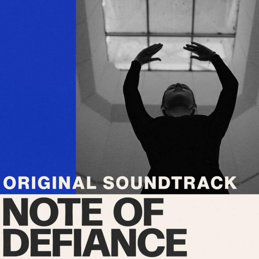 The album cover of the 'Note of Defiance' original soundtrack shows a person with arms raised and hands near a skylight, with a mostly black-and-white color scheme and a blue accent on the left side.