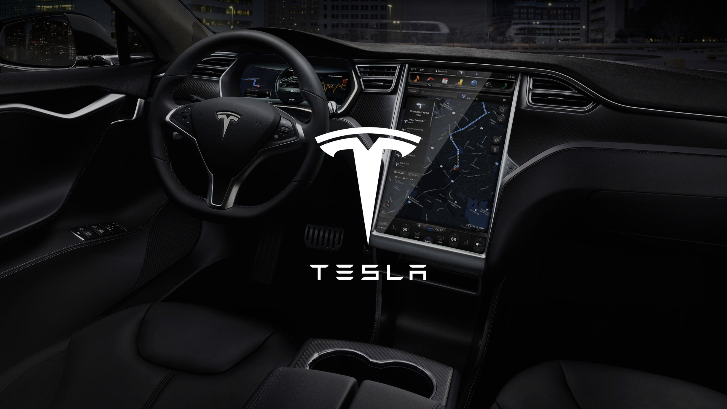 The interior of a Tesla electric vehicle at night, showing the dashboard, steering wheel, large central touchscreen displaying navigation, and Tesla logo overlay.