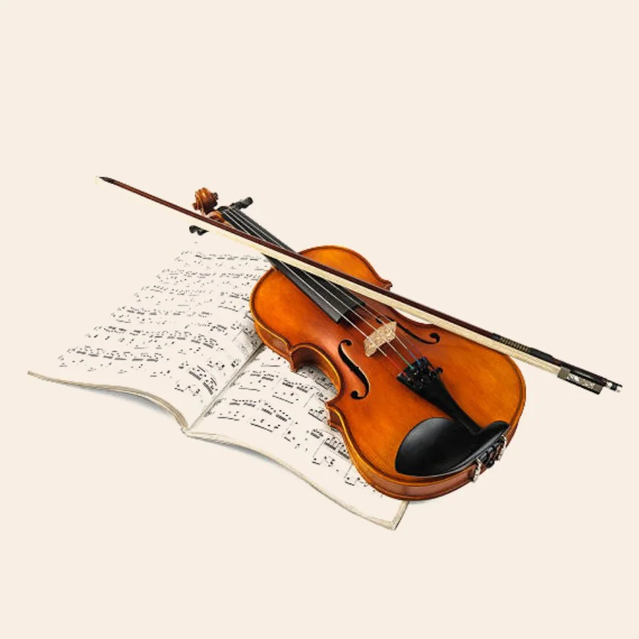 Violin and bow on top of an open book of sheet music.