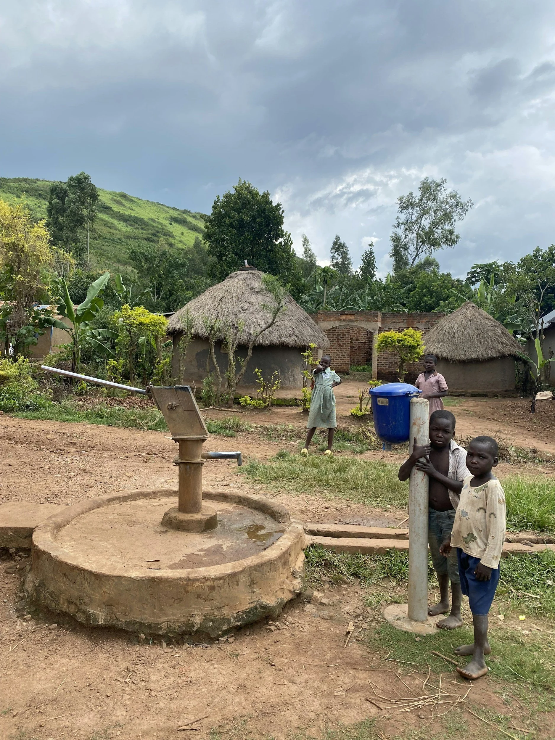 Water well in Uganda with children