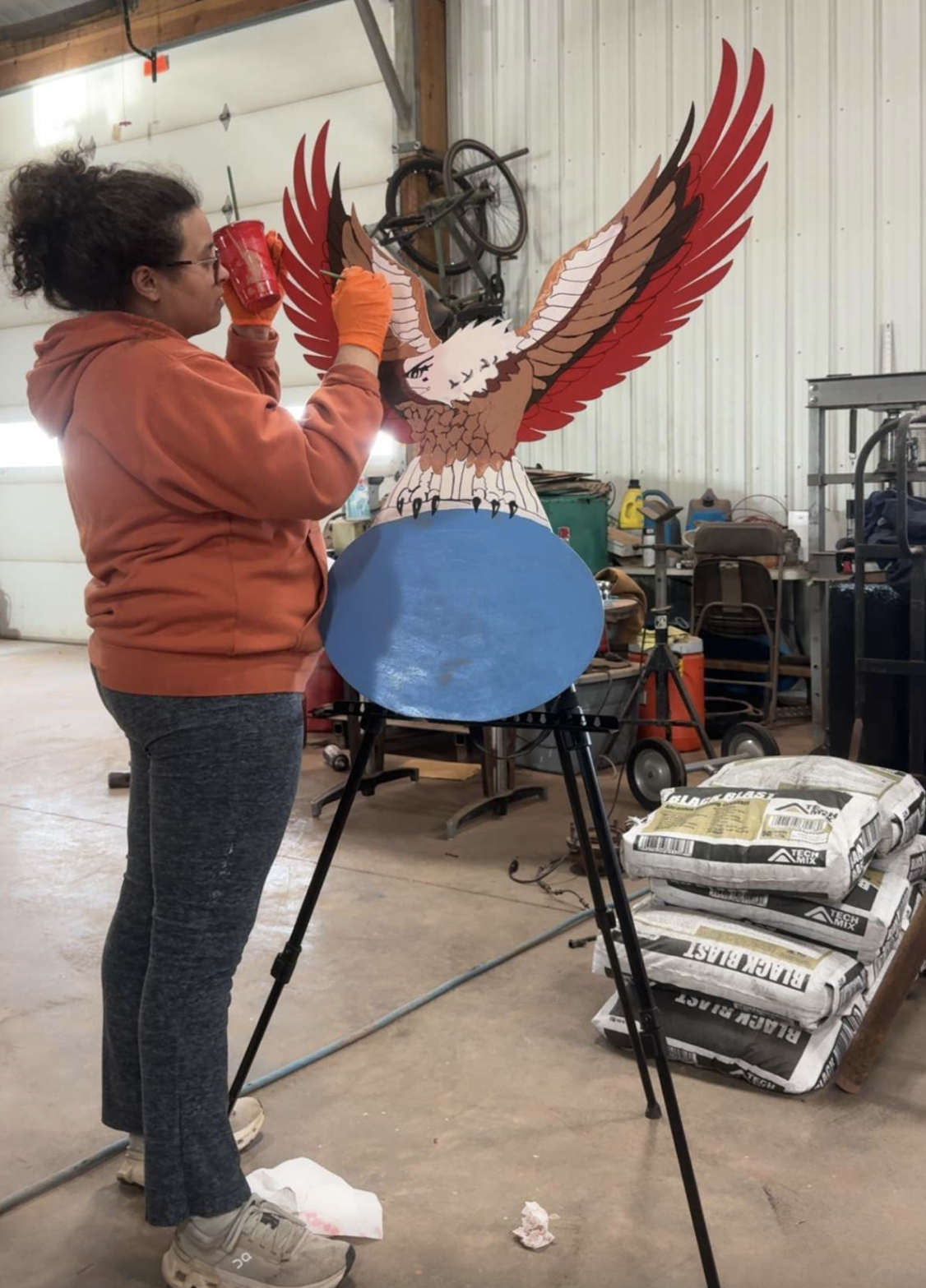 photo of marisa painting custom cut sign .png