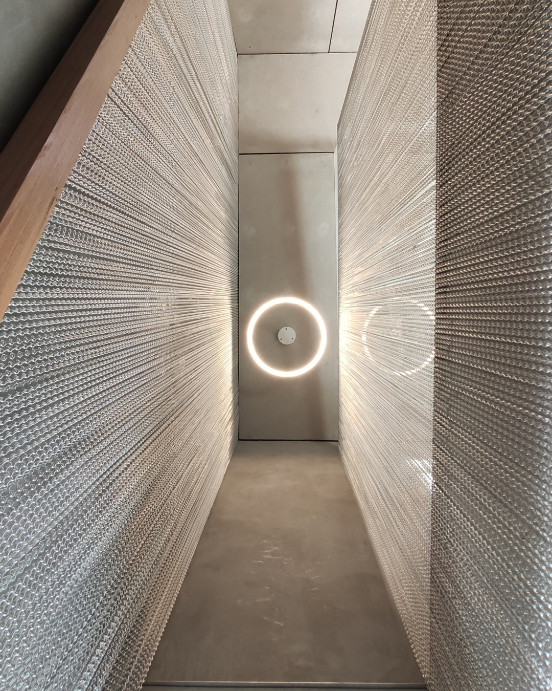 Beautiful image of metal chains, concrete finish and and halo light of one of the terrace house projects by Terrace Transformations