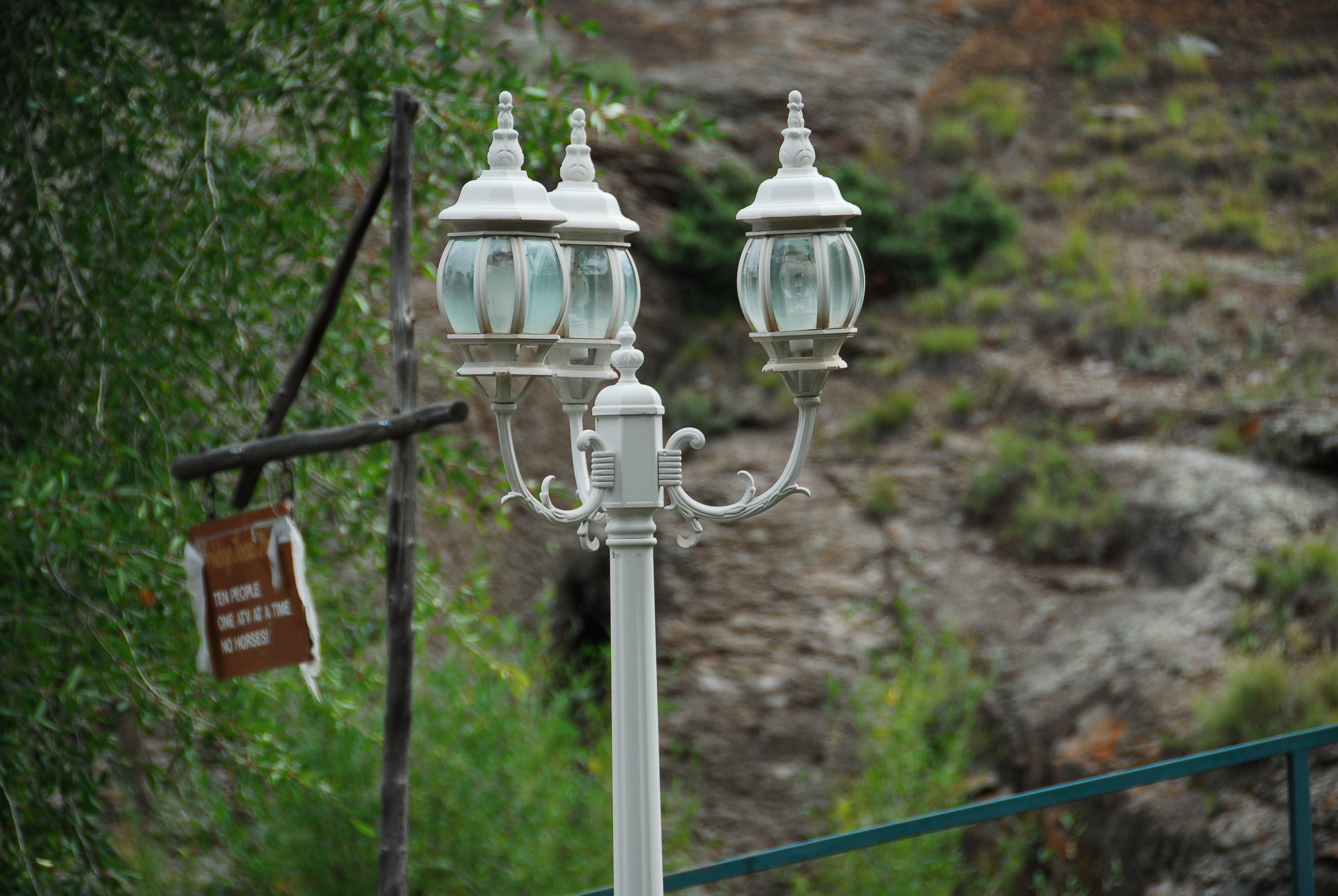White decorative street lamp with three lanterns