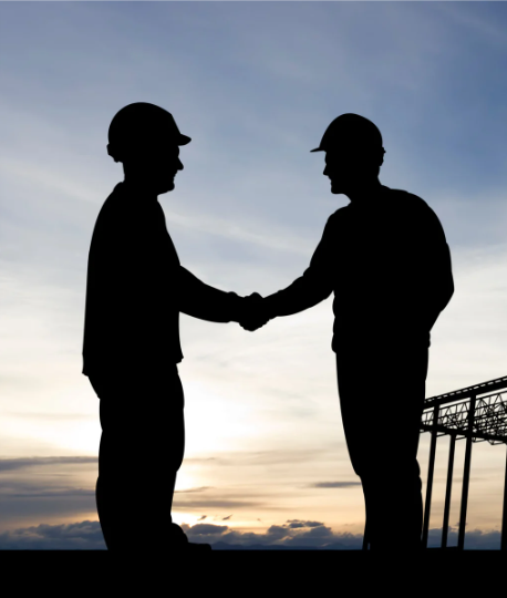 construction site workers shaking hands