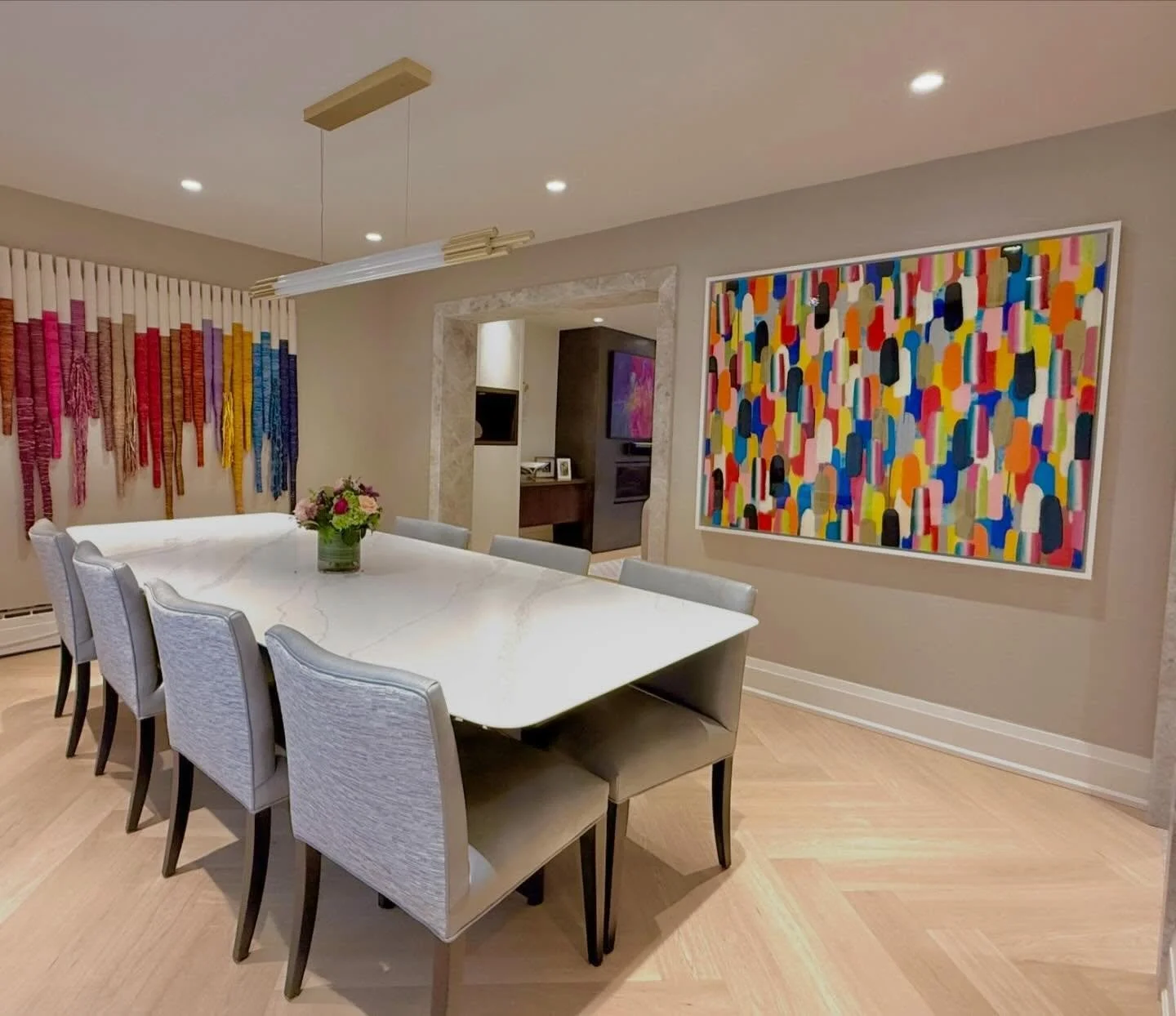 What a fun dining room!  The bold colours of 'Tailgate' work with the adjacent wall's large multi-coloured textile piece, creating a harmonious and playful space. The high gloss of the painting is reflective and will be so pretty for evening dining. 