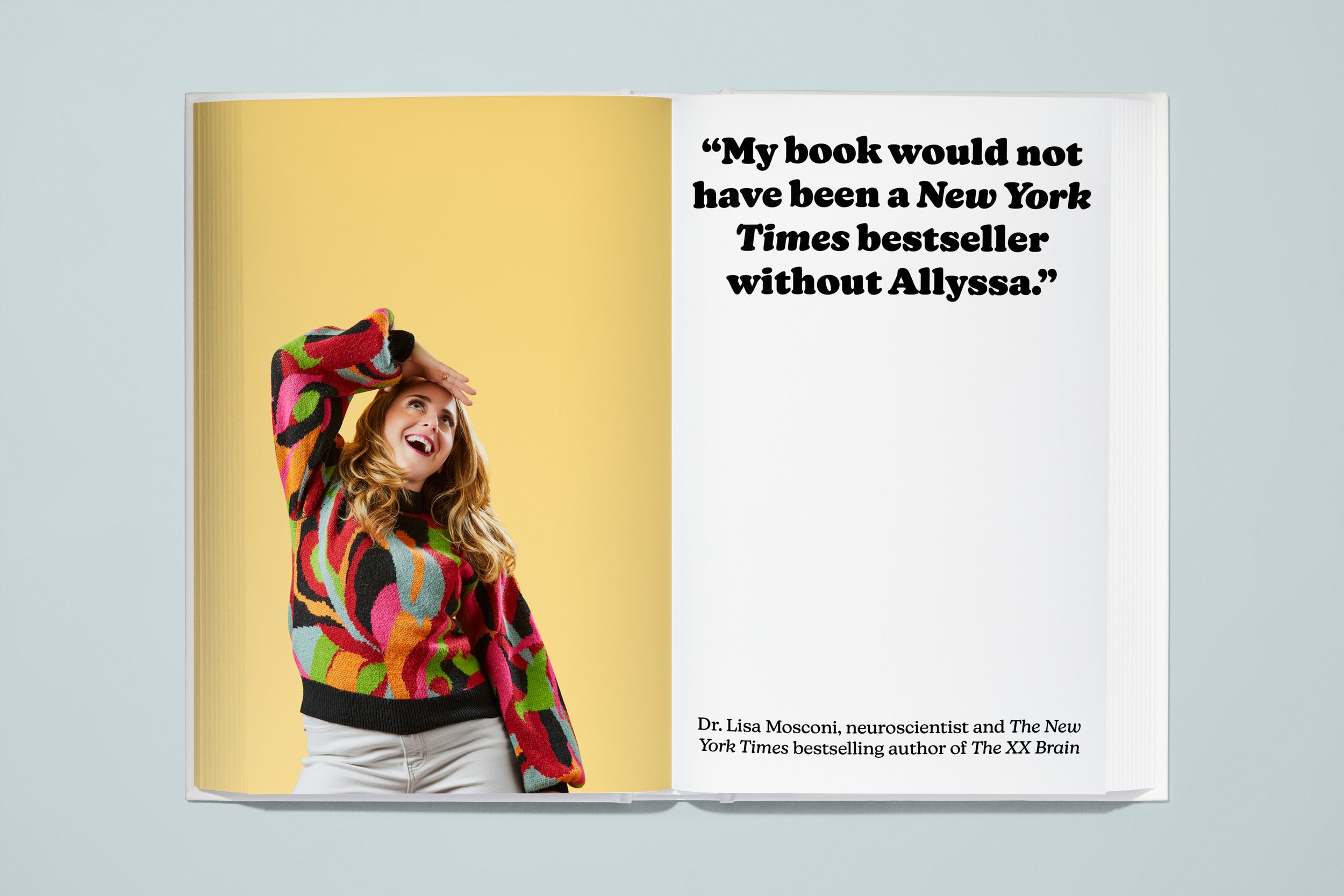 Open book with a photo of a woman wearing a colorful, patterned sweater, smiling and holding her forehead, on the left page. The right page contains a quote: "My book would not have been a New York Times bestseller without Allyssa." and a caption: Dr