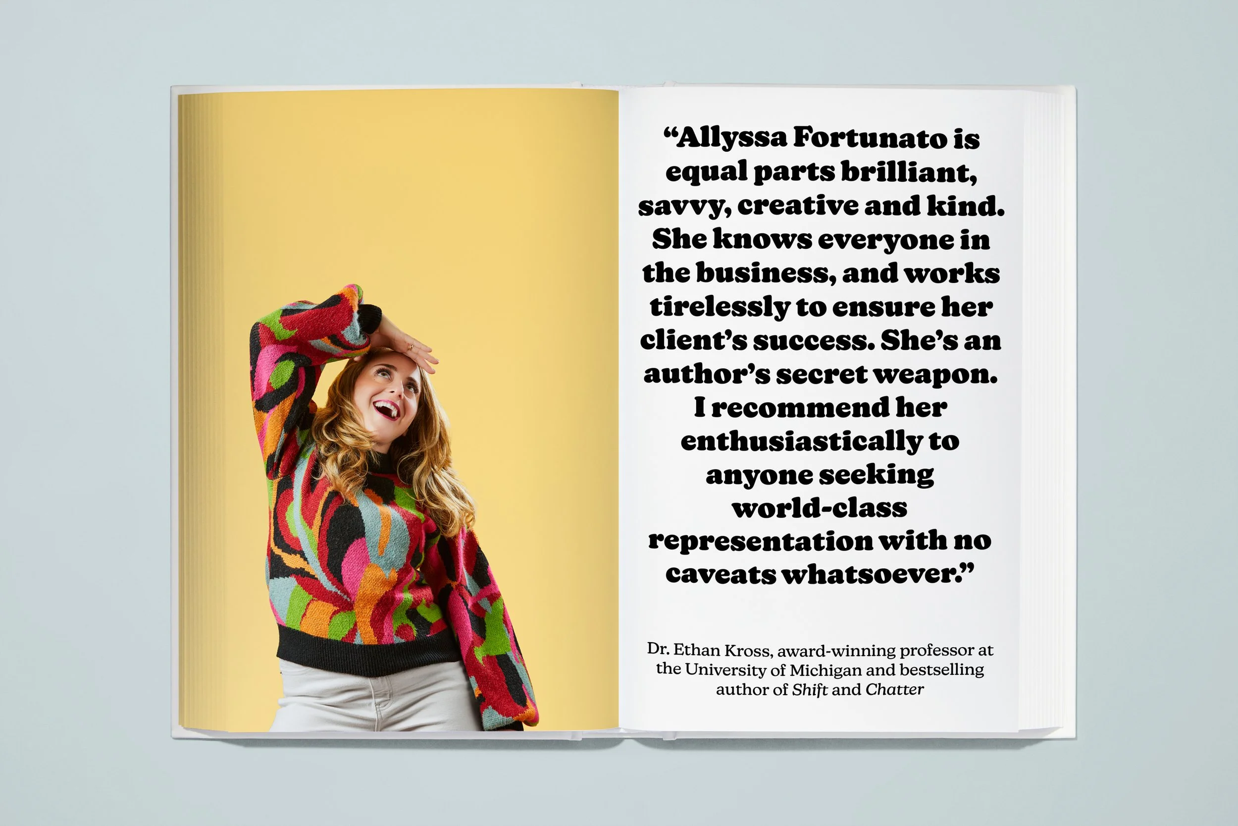 Open magazine featuring a woman with long hair wearing a colorful patterned sweater, smiling and looking up, against a yellow background on the left page. The right page contains a quote about Allyssa Fortunato, praising her brilliance, creativity, a