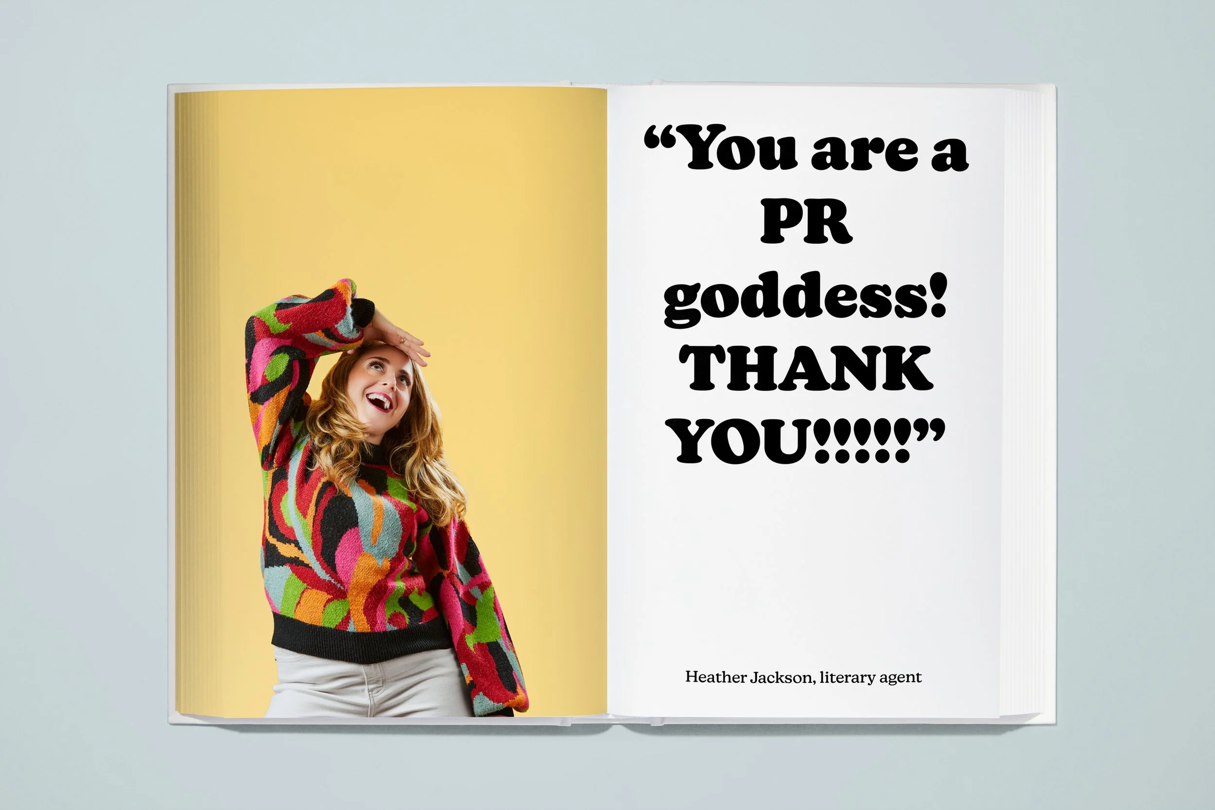 Open book with a woman in a colorful sweater smiling and looking up on the left page, and a quote on the right page that reads "You are a PR goddess! THANK YOU!!!!!!" with a small credit to Heather Jackson, literary agent.