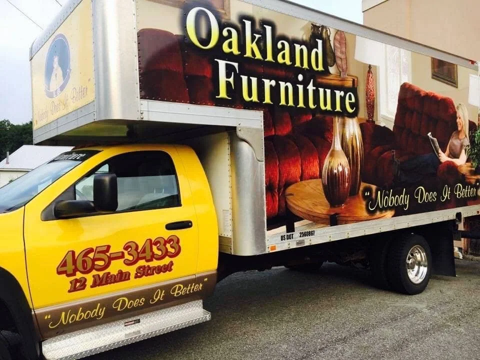 Oakland Furniture delivery box truck parked outside, representing local furniture delivery service from Oakland, Maine.