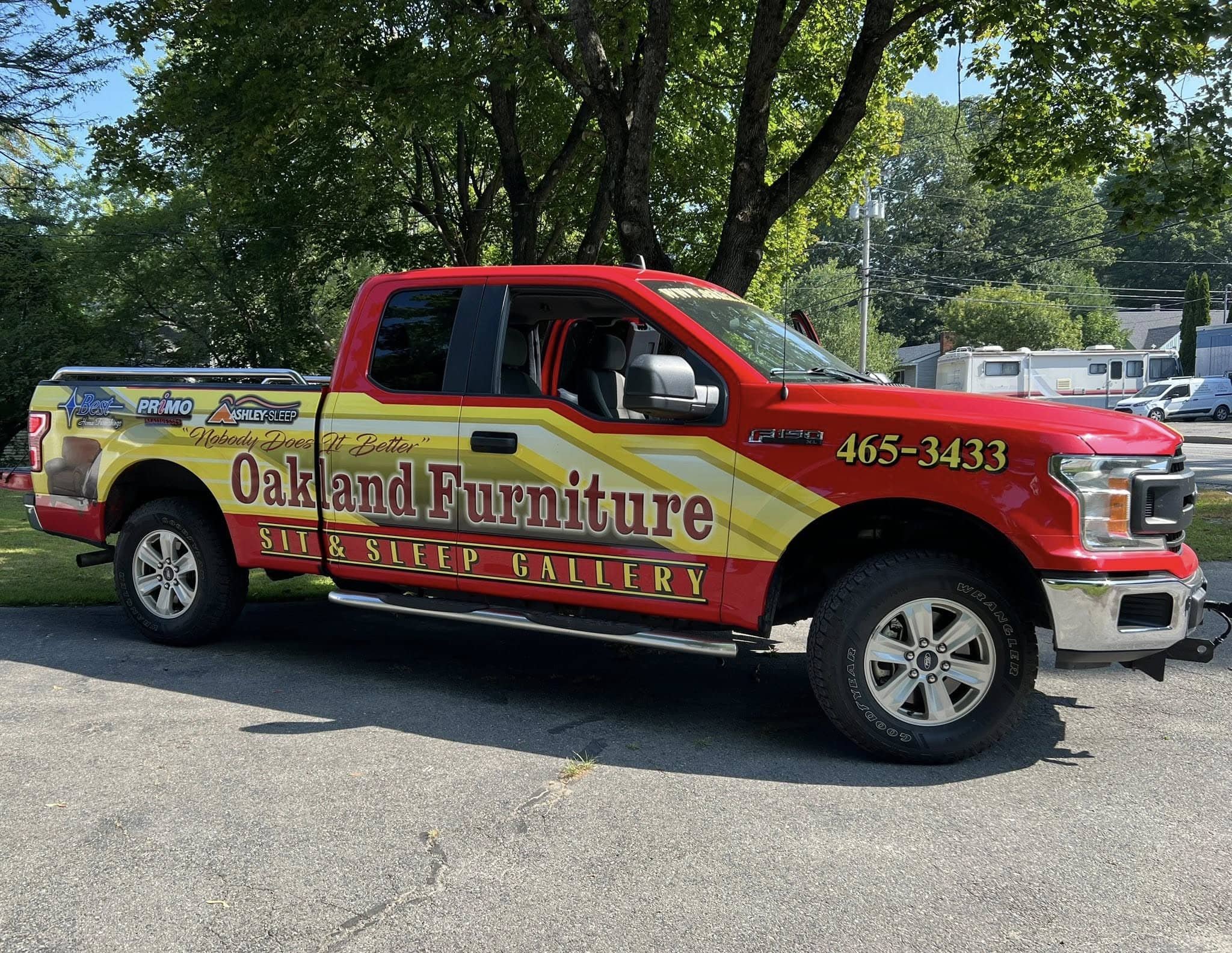 Oakland Furniture delivery pickup truck parked outside, representing reliable local delivery and old furniture removal service.