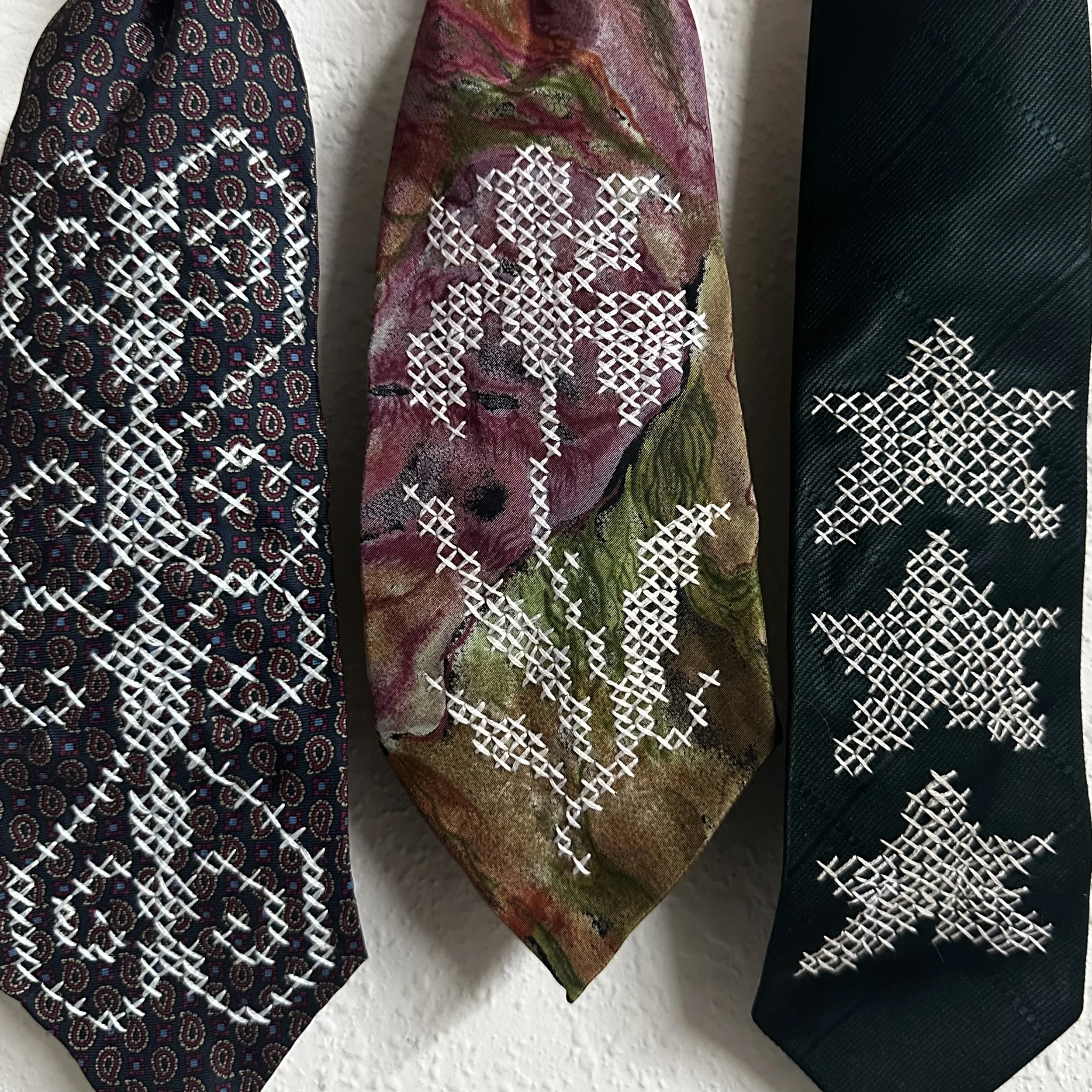 Hand-embroidered necktie trio: Iron, Iris, and Star, 2026